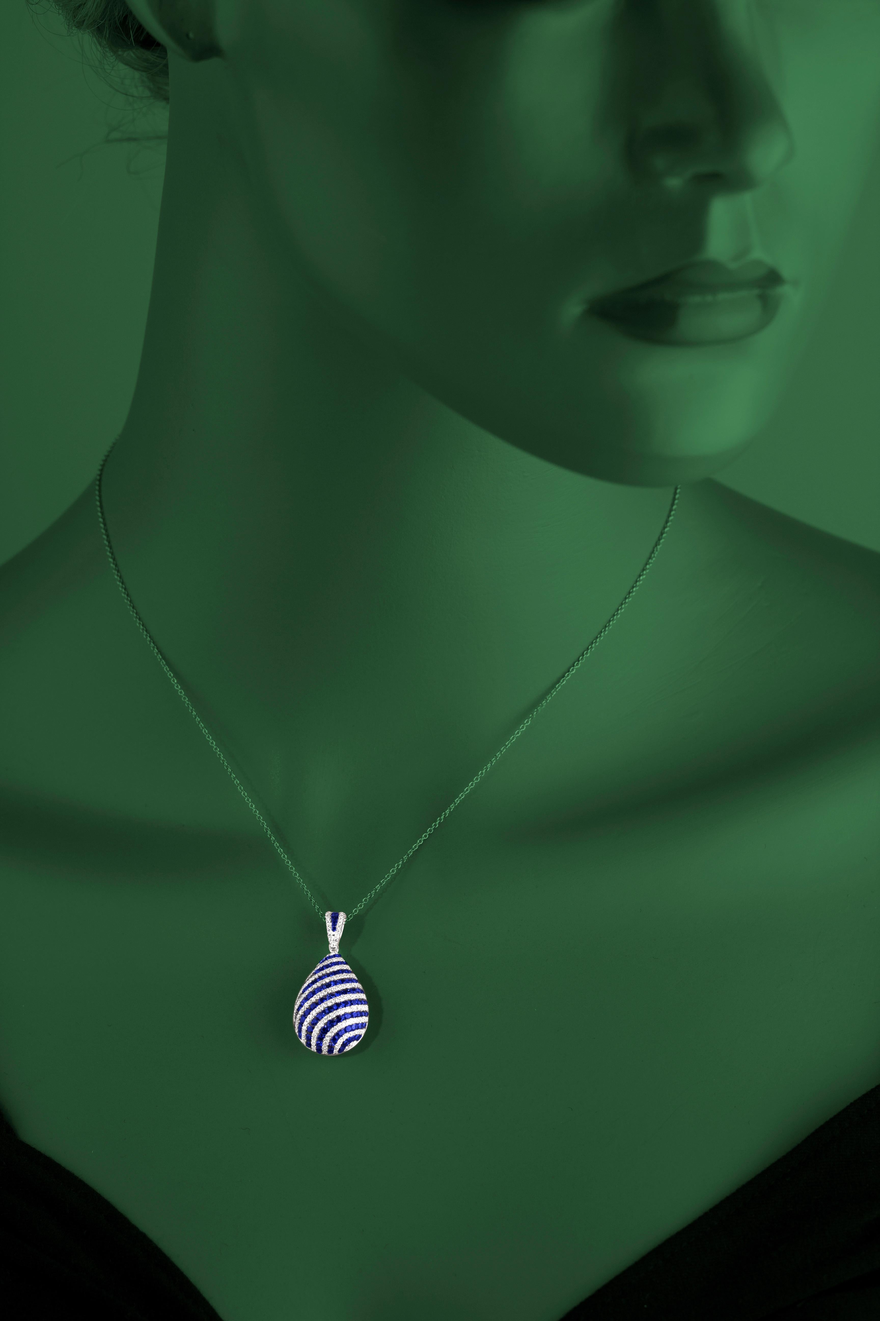 Indulge in the breathtaking beauty of this stunning teardrop pendant, a masterpiece that harmoniously blends the rich allure of blue sapphires with the brilliance of natural white diamonds. This pendant is a true symbol of elegance and