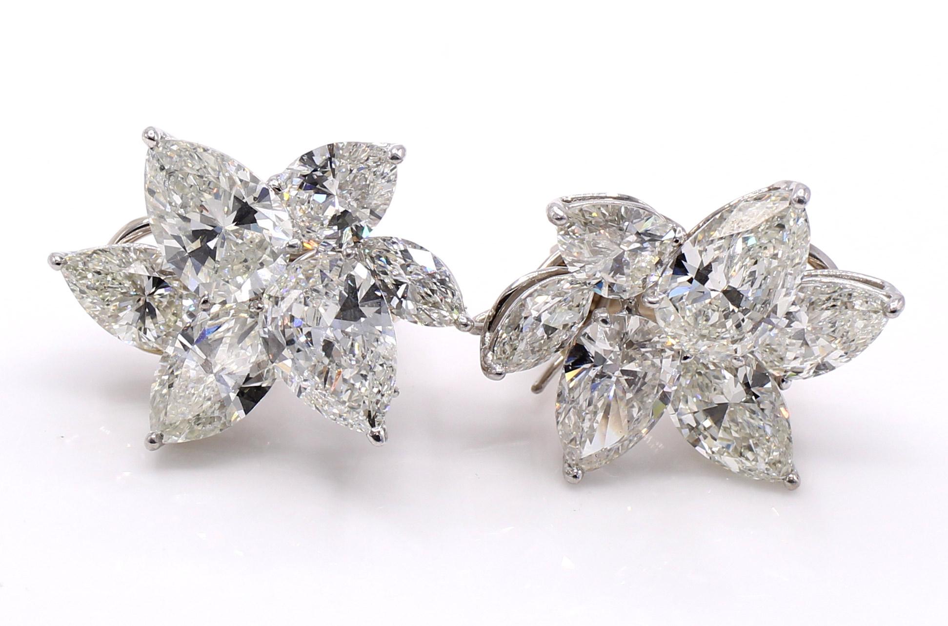 Unique pair of finely handcrafted platinum diamond cluster ear clips. In the Winston-Style, the pear shaped diamonds are set at various levels to give the earring a true three-dimensional appearance with maximum brilliancy. With the largest pear
