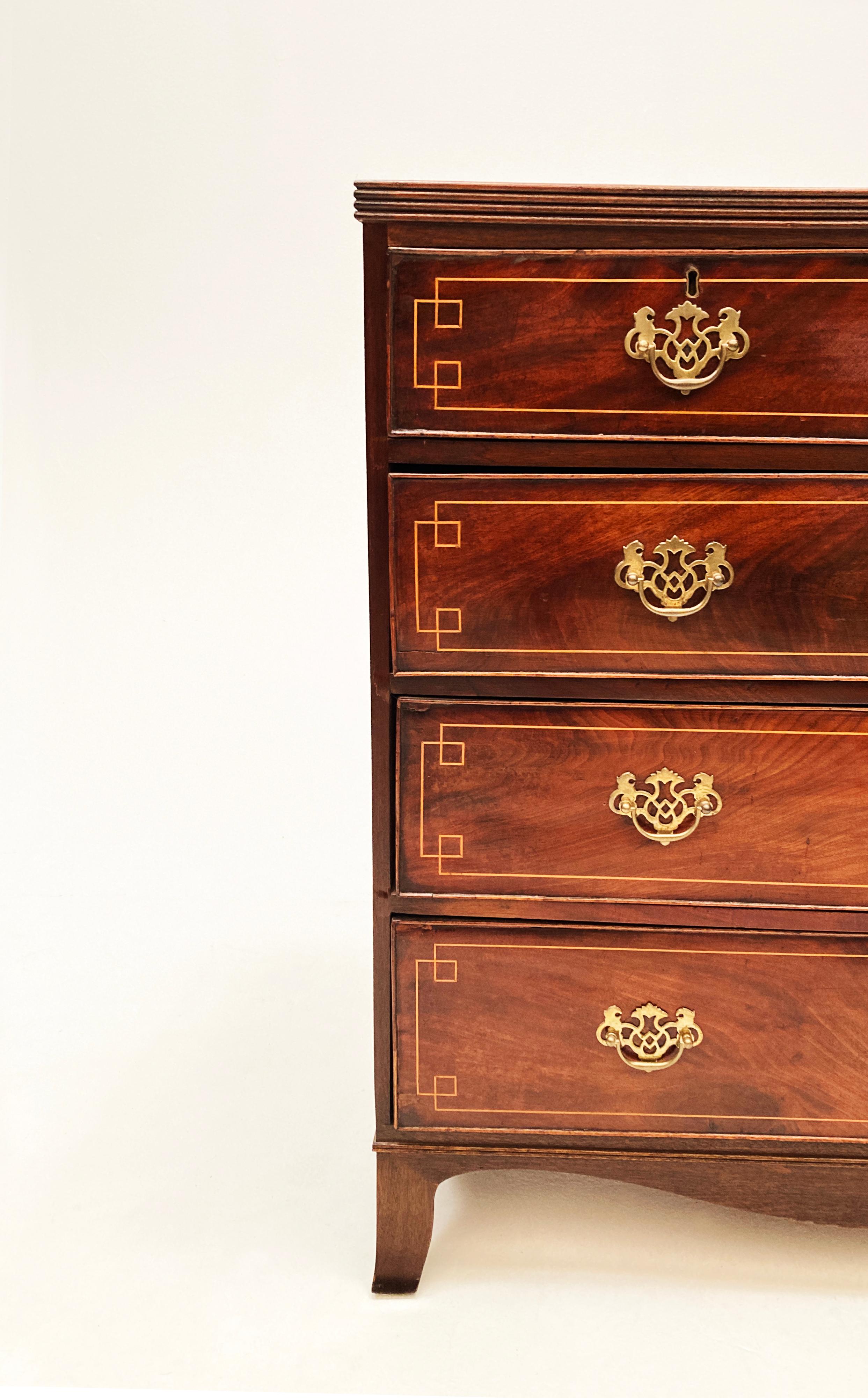This is perhaps one of our favorite pieces and one of the most sophisticated and uniquely finished chests from the mid 18th century. An English - King George III, Hepplewhite flame mahogany five-drawer dresser with rosewood banded surface edge