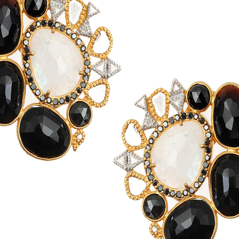 Affinity Earrings Set in 20 Karat Yellow Gold with 17.41-carat Black Spinel, 8.40-carat Rainbow Moonstone, 0.07-carat Orange Sapphire, and 0.07-carat Tsavorite. These earrings are set with 0.89-carat Diamonds as well. These earrings feature a