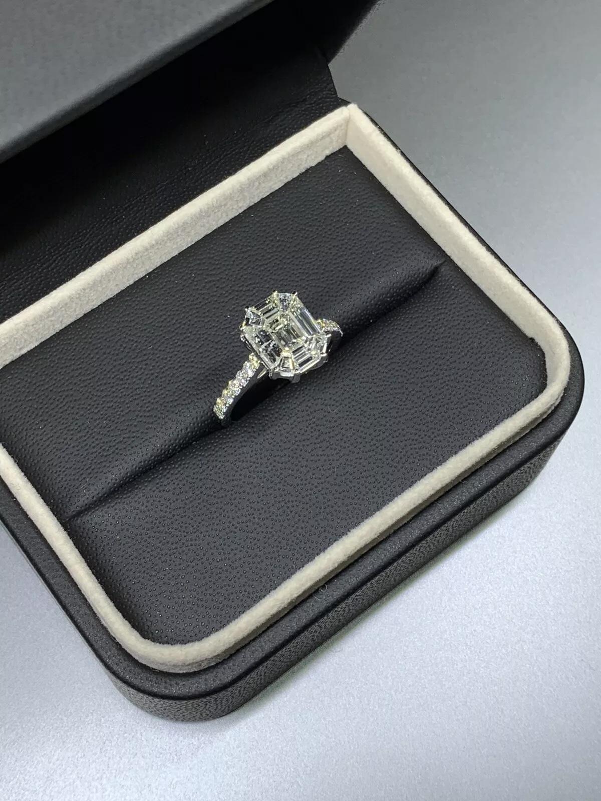 1.74ct Emerald diamond pave band engagement ring in 18k white gold.

Large emerald diamond invisible set baguette and step cut diamonds together in 18ct white gold ring.

Diamond centre stone invisible set 1.35ct pave diamonds 0.39ct. Large emerald