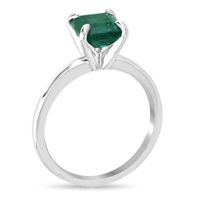 Introducing our Solitaire Emerald Ring, featuring a stunning 1.74 carat Asscher-cut emerald with a vivid medium green color, sourced from the renowned mines of Zambia. This natural gemstone, celebrated for its exceptional beauty and unique