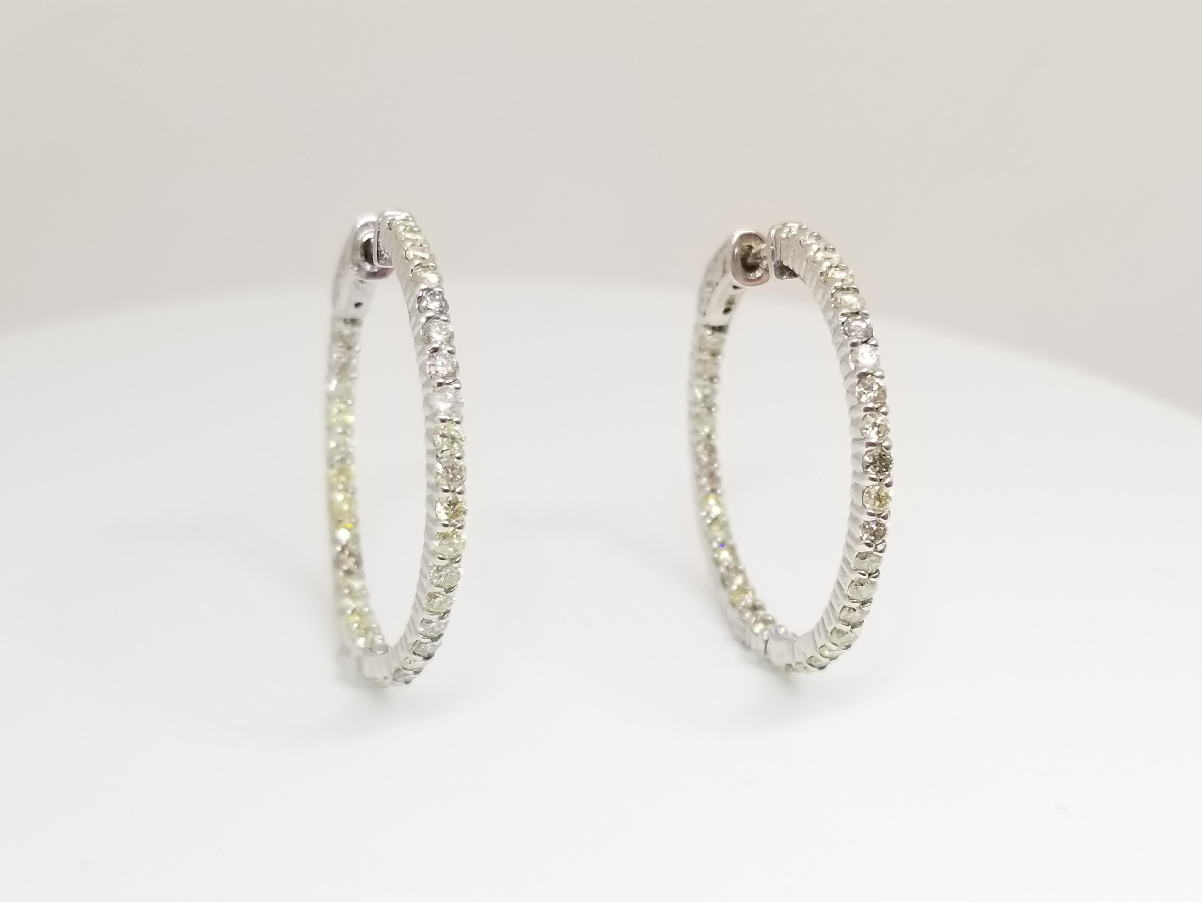 Beautiful pair of huggie diamond inside out hoop earrings available in 14k white gold. Secures with snap closure for wear.  Measures 1 inch in diameter. Beautiful for the holiday!