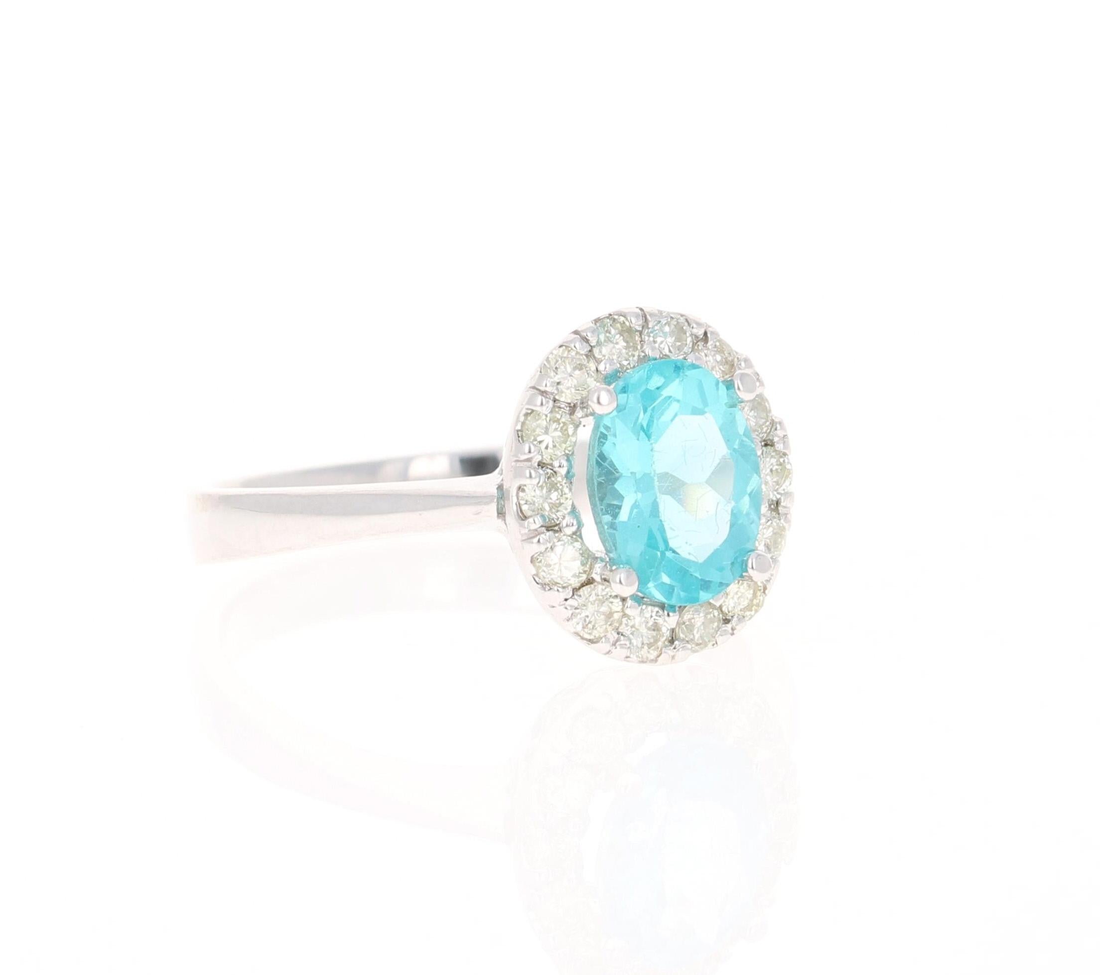 Gorgeous Halo Apatite and Diamond Ring. This ring has a Oval Cut 1.39 carat Apatite in the center of the ring and is surrounded by a halo of 14 Round Cut Diamonds that weigh 0.36 carat (Clarity: SI, Color:F). The total carat weight of the ring is