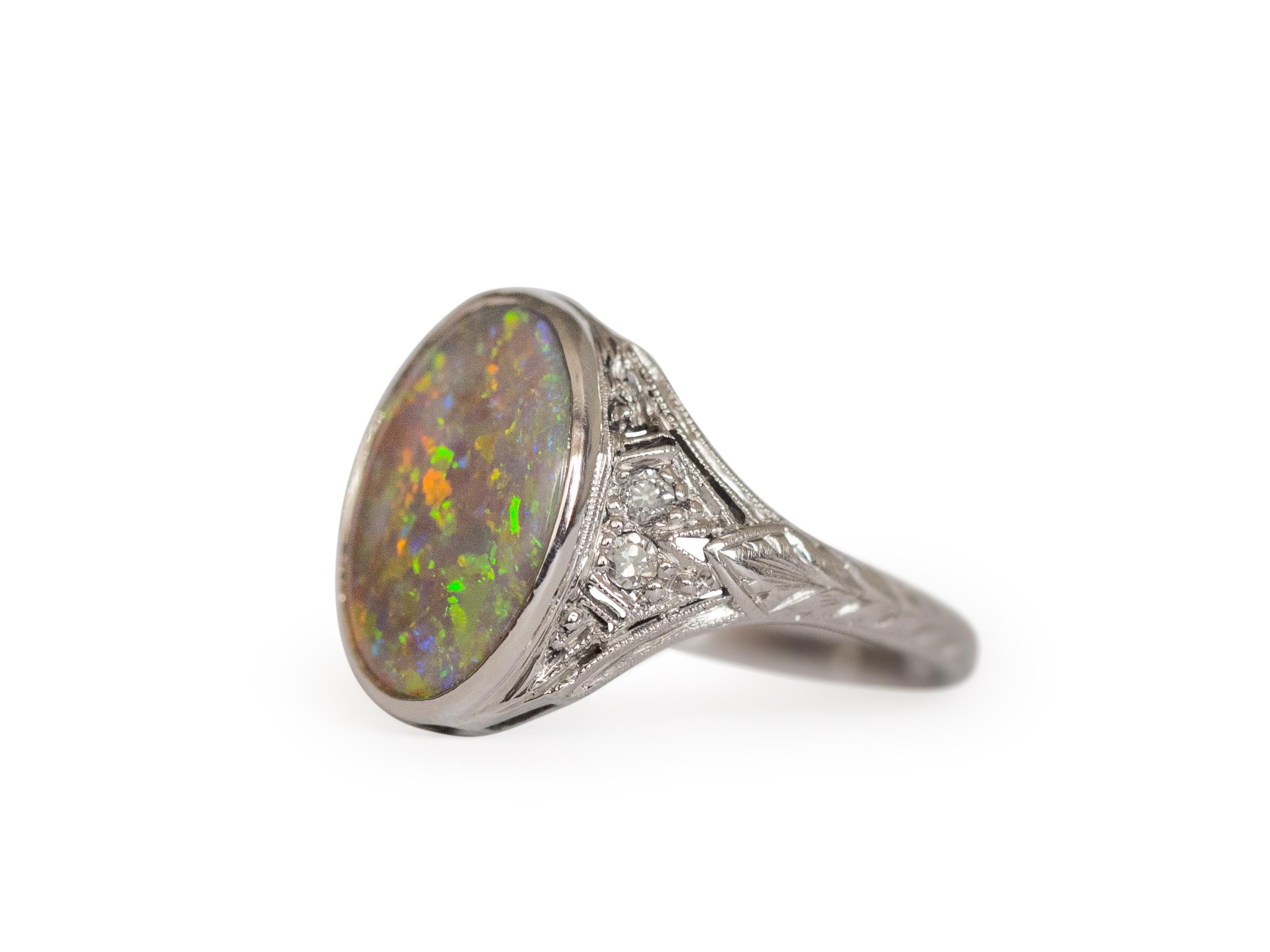 Ring Size: 6
Metal Type: Platinum [Hallmarked, and Tested]
Weight: 4 grams

Center Opal  Details:
Weight: 1.75 carat
Cut: Oval
Color:  Mixed colors

Side Diamond Details:
Weight: .20 carat, total weight
Cut: Old European
Color: G-H
Clarity: