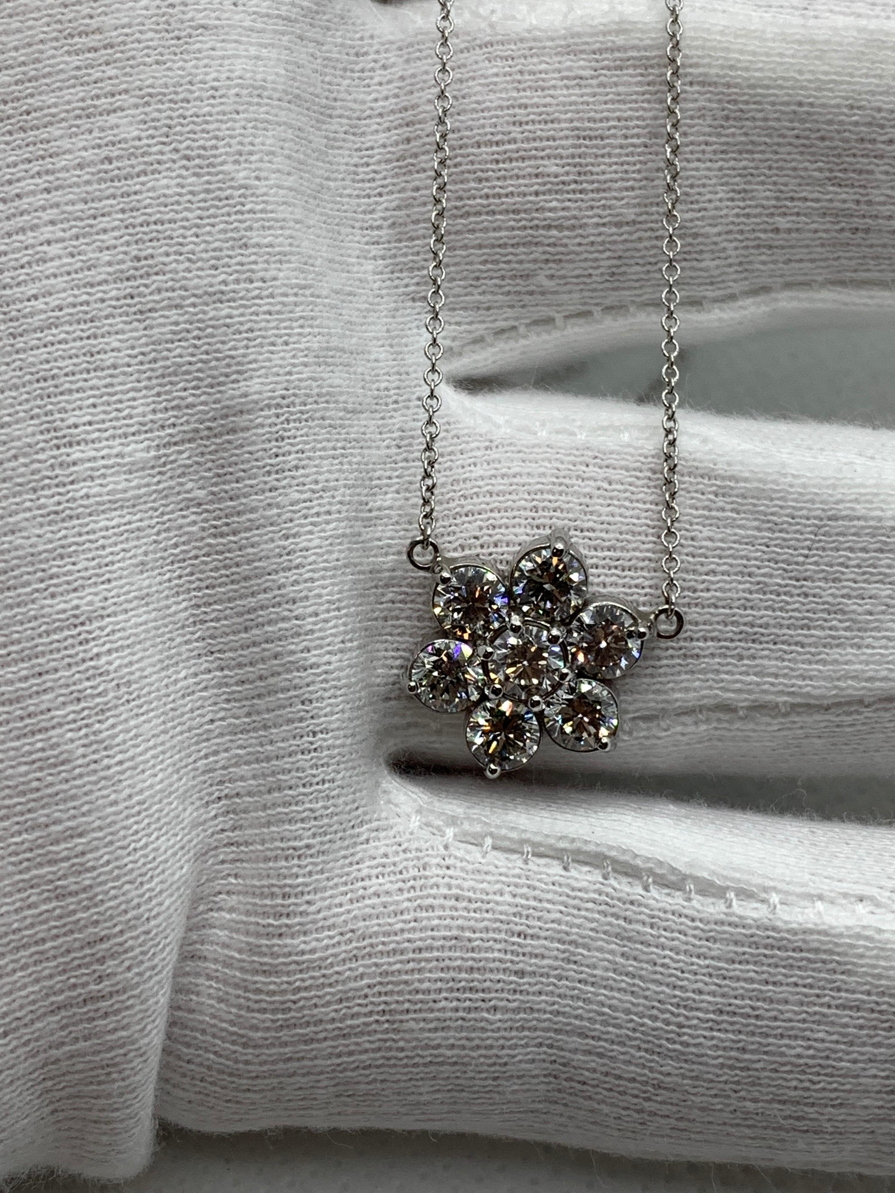 7 Round Brilliant Diamonds come together to form a beautiful Flower Cluster. Laying low and effortless on the neck, this pendant goes with anything and can be worn anywhere. 

1.75 Carats. Each Stone weighs 0.25 Carat. Set in 14 Karat White Gold.