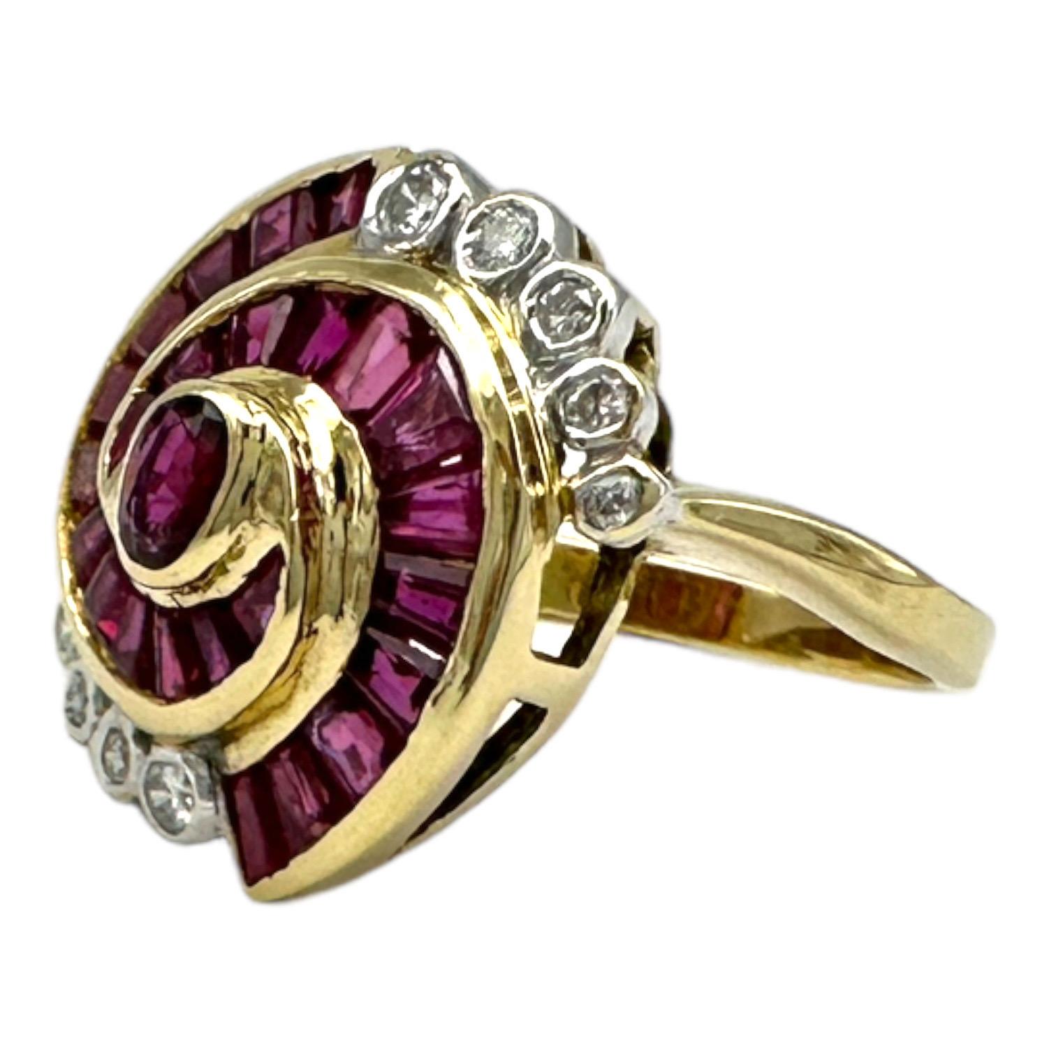 14 karat yellow gold ruby and diamond cocktail ring is 16 mm in diameter and has beautiful red-colored rubies. A swirl of baguette-cut rubies circles a centered oval-shaped ruby. Twenty-two rubies weigh an estimated 1.50 carats. The ring's outer