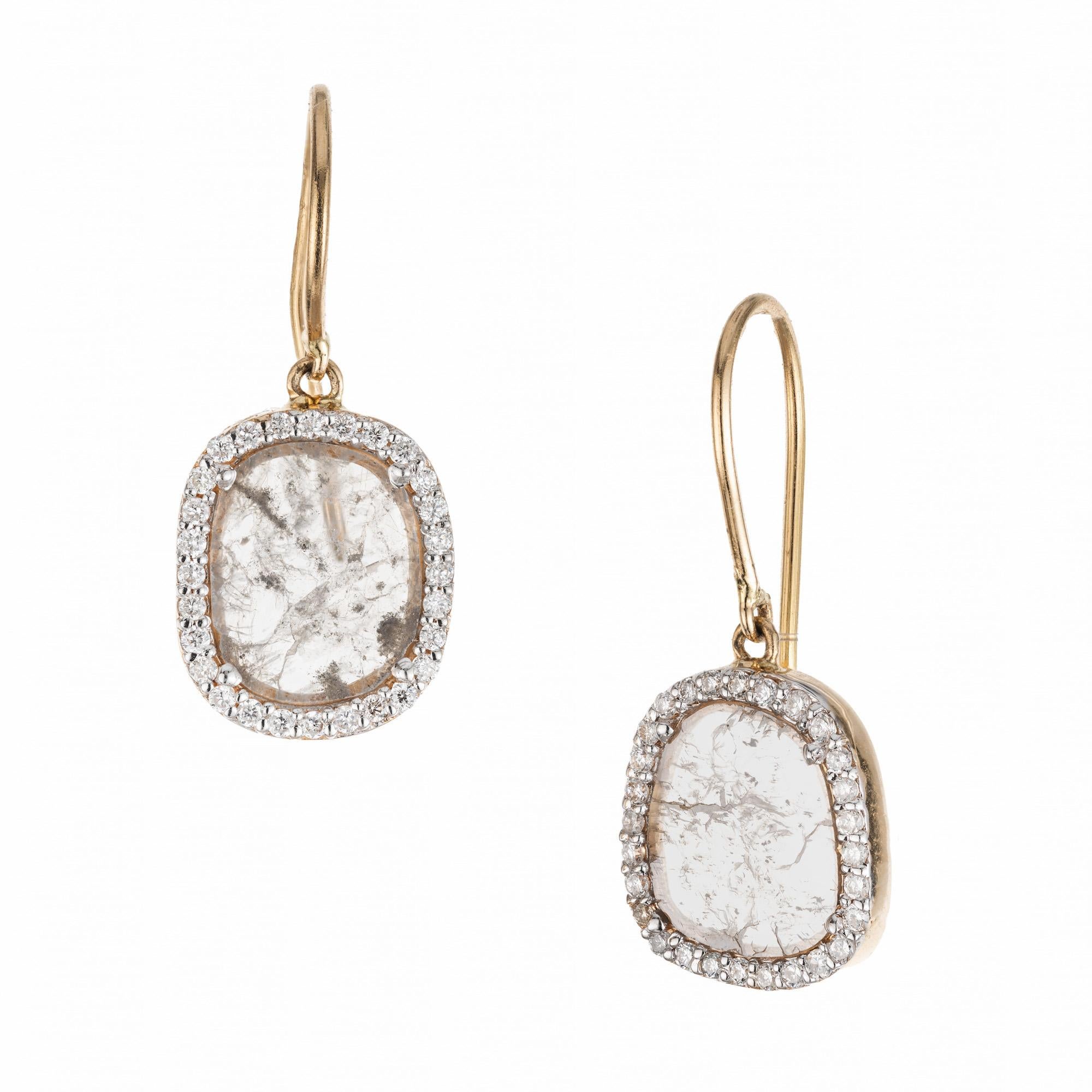 Salt and Pepper Diamond Halo Yellow Gold Dangle Earrings combine elegance and unique style. A beautiful combination of salt and pepper diamonds set in a halo design. The two diamond slices are each enhanced with a halo of 28 round cut diamonds. The