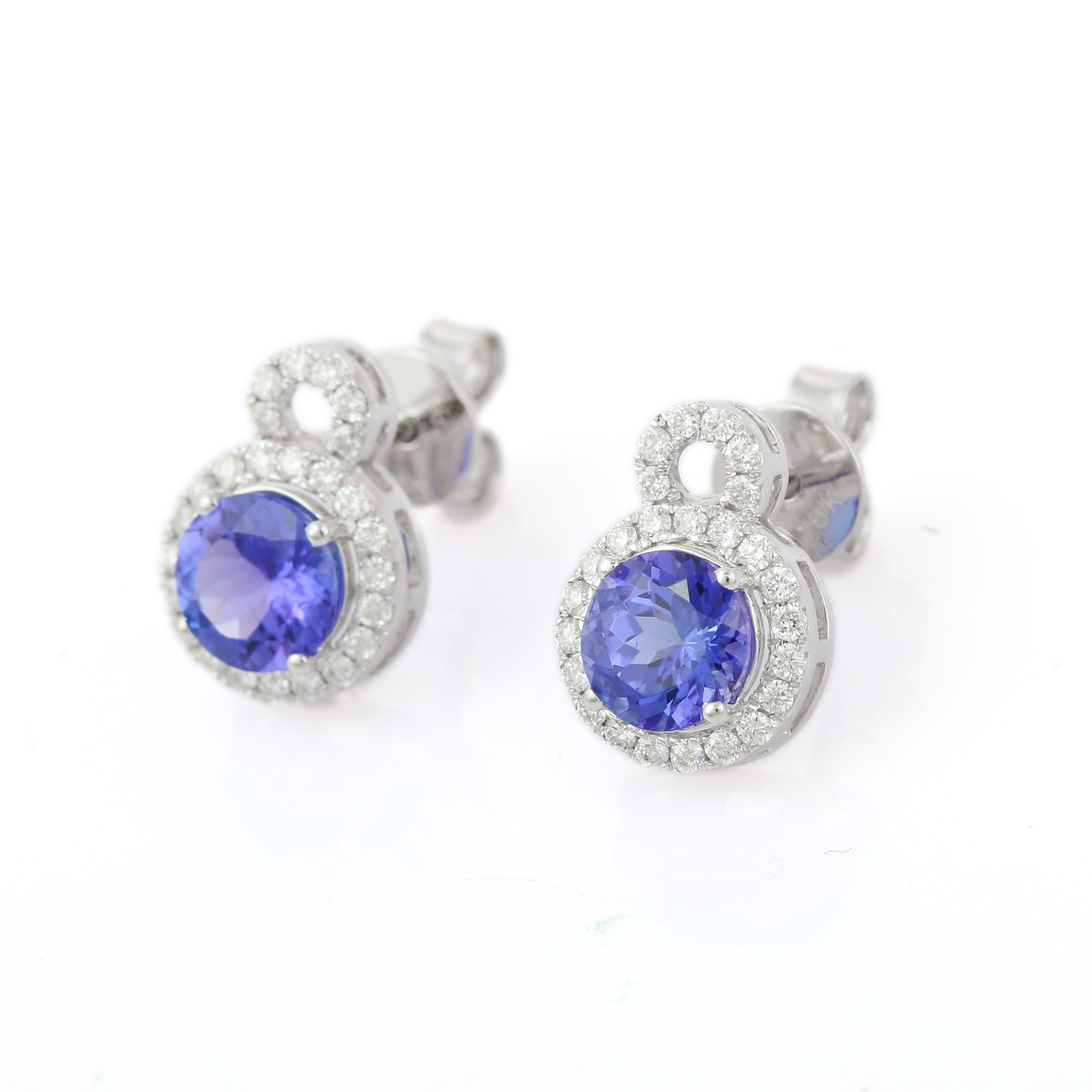 Studs create a subtle beauty while showcasing the colors of the natural precious gemstones and illuminating diamonds making a statement.

Round cut tanzanite studs with diamonds in 18K white gold. Embrace your look with these stunning pair of