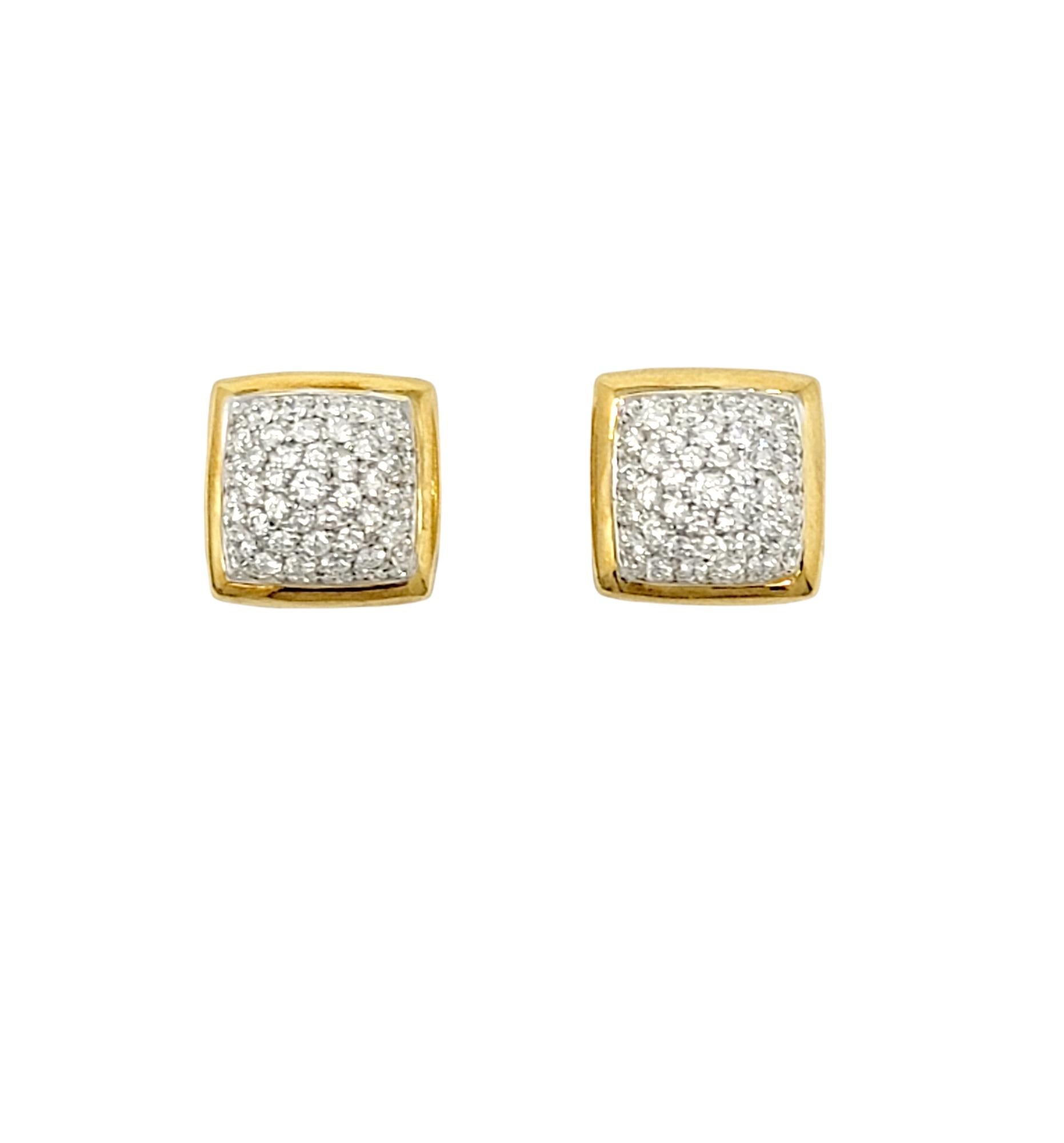 Stunningly sparkly pave diamond stud earrings. These simple yet elegant earrings are bursting with glittering diamonds and give off a modern sophistication. They feature a square shaped base in polished 18 karat yellow gold, and are filled with