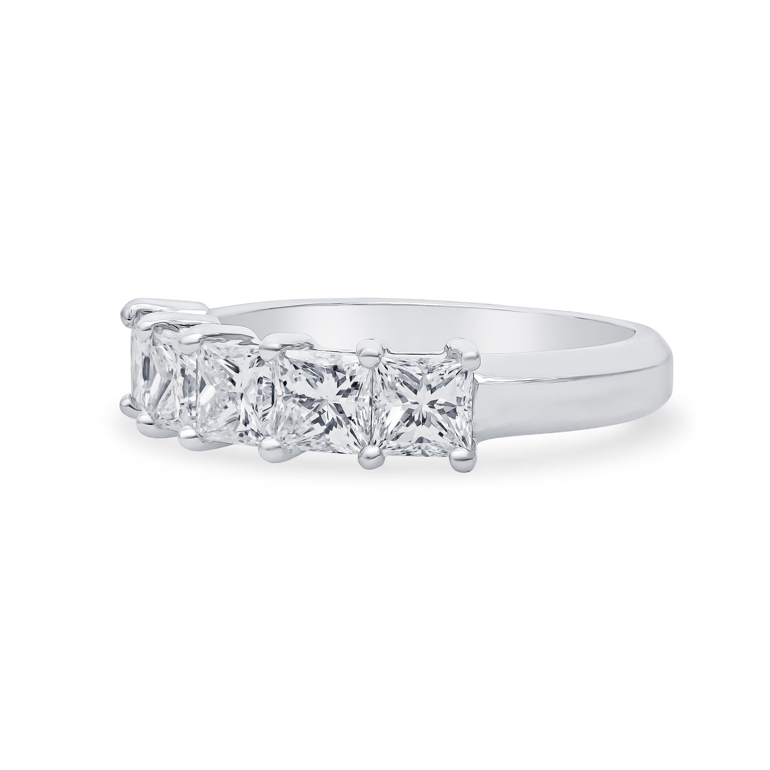 Approximately 1.75 carats total of five princess cut natural diamonds set in a platinum wedding band, size. This timeless design can be paired with your engagement ring or worn alone as a statement piece. It is currently a size 6.5 and may be easily