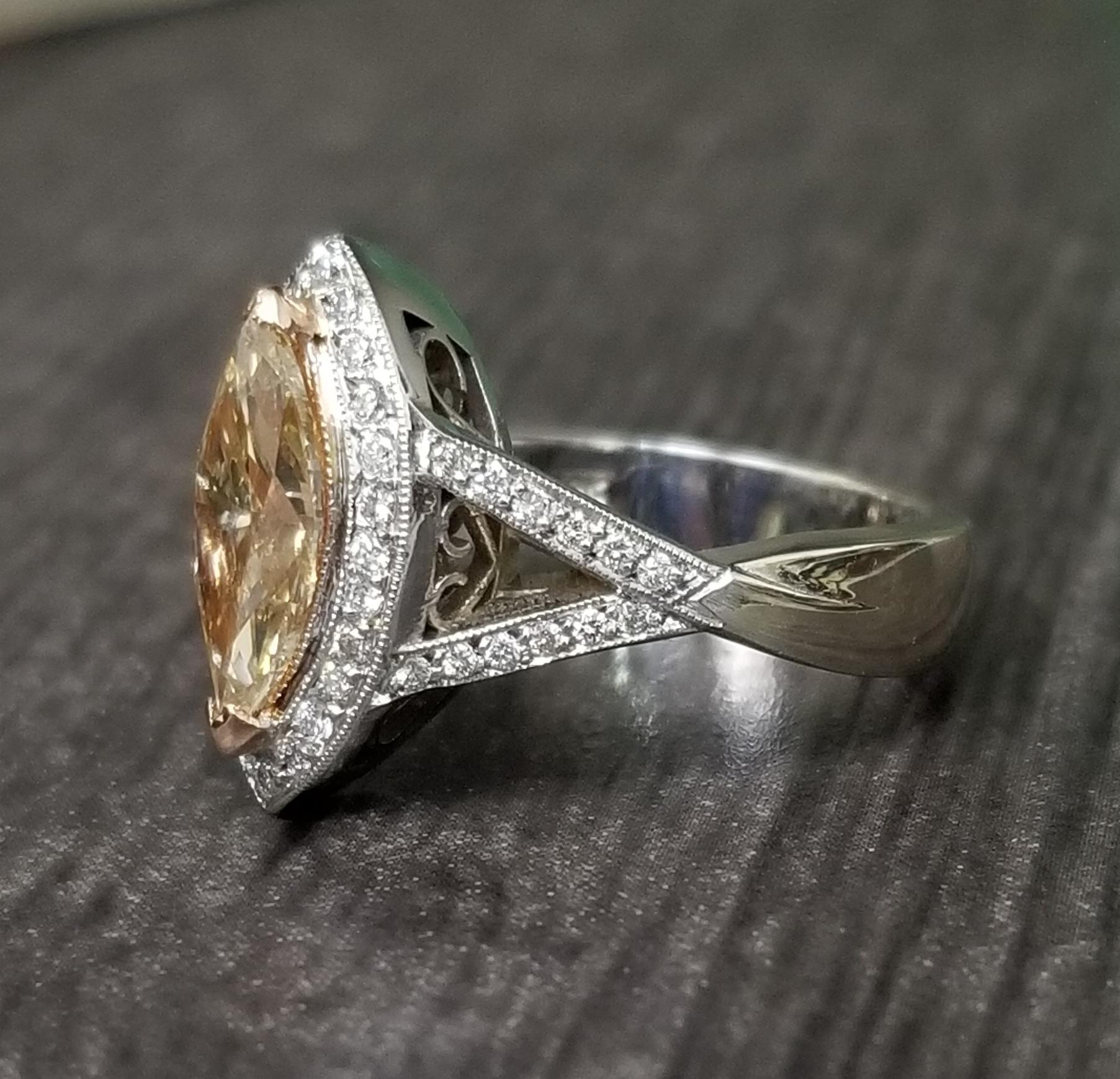 14k white gold ladies diamond ring containing 1 marquise cut diamond; color 