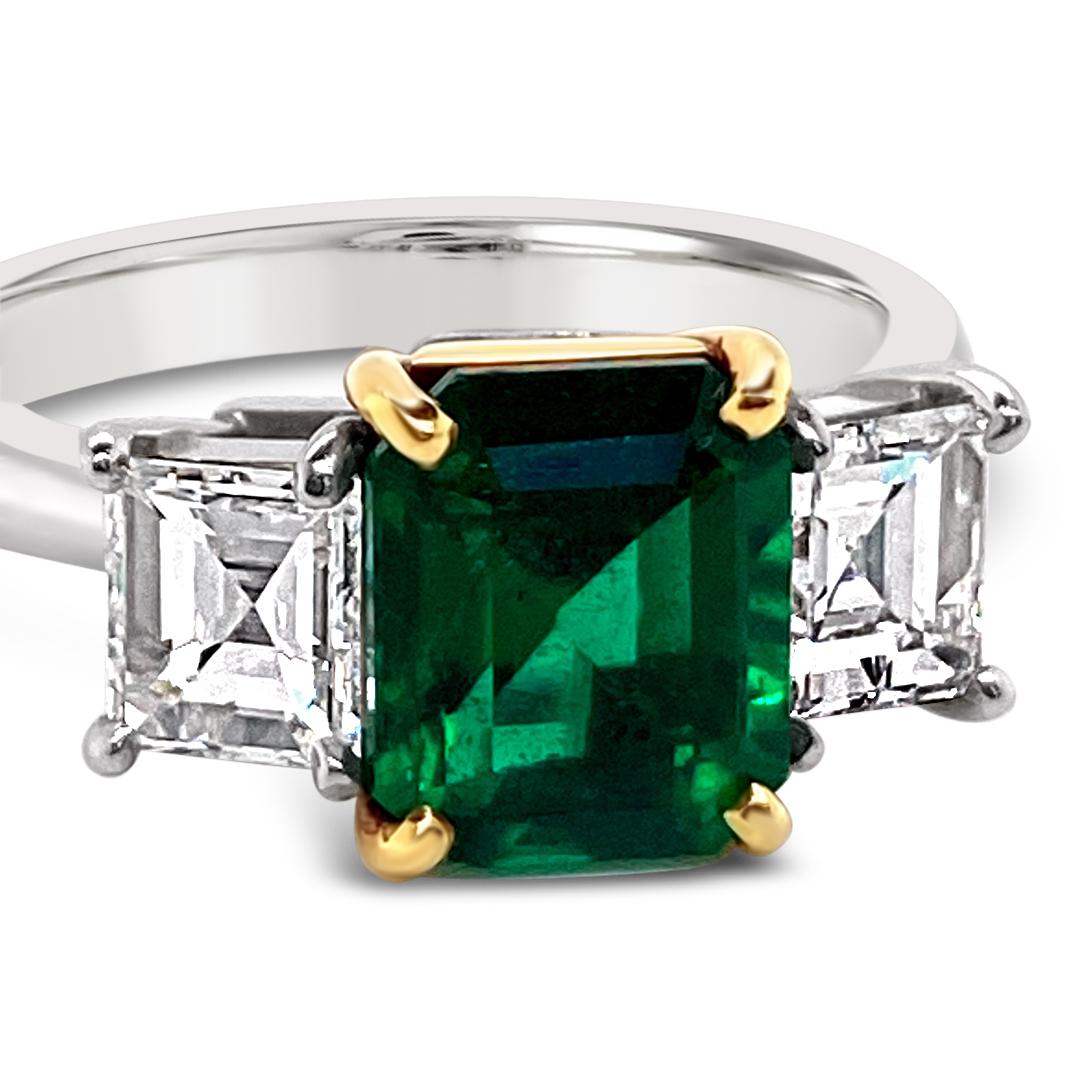 1.75 Carats Emerald and Diamond Ring.  Side diamonds are Emerald cuts weighing 0.98 Carat (total weight).  Set in Platinum with 18K Yellow Gold mounting.
