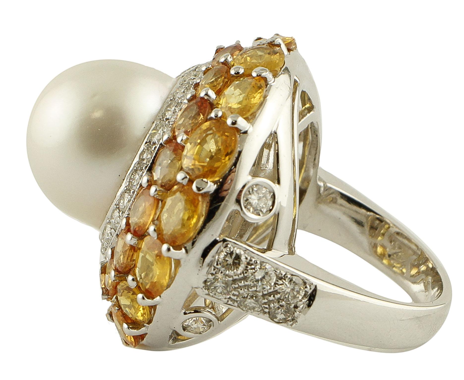 Fabulous cluster ring in 14K white gold structure mounted with 4 g of glossy white pearl (14 mm) in the center surrounded by diamonds crown and studded all around by 13.20 ct of yellow sapphires.
Diamonds 1.75 ct 
Yellow Sapphires 13.20 ct
Pearl 4 g