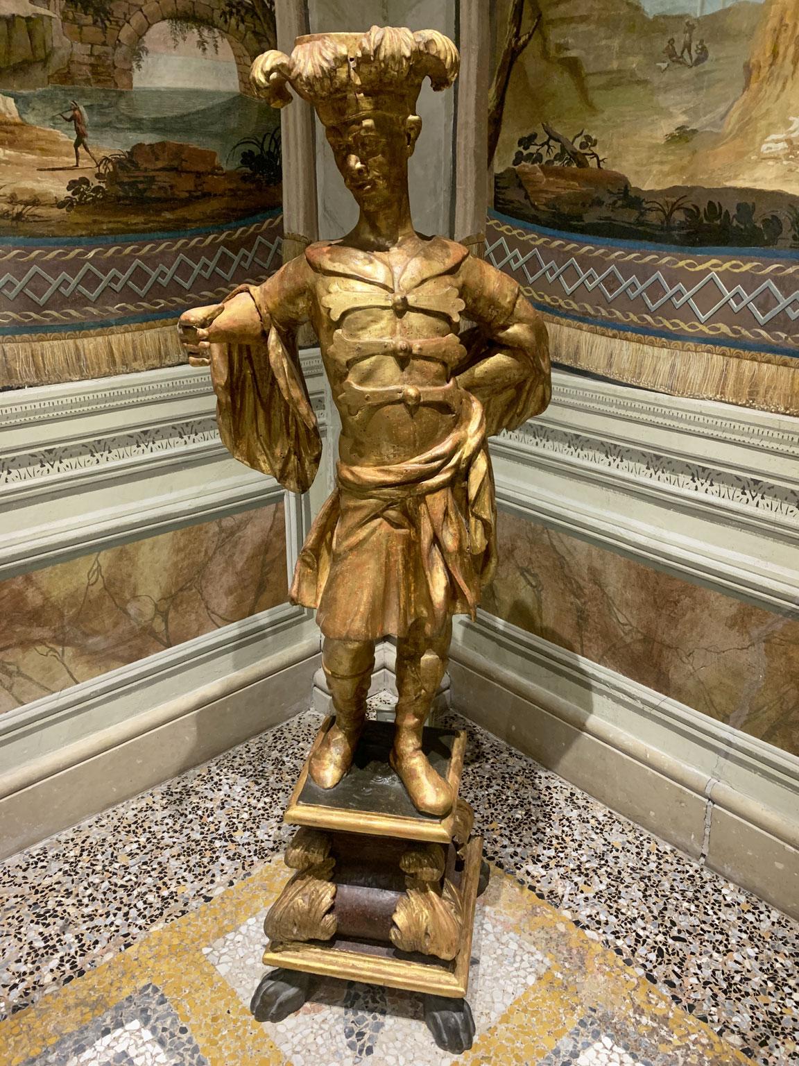 This is an extraordinary pair of warriors sculpted and engraved in gilted   wood. These pieces hail from the Mid-18th Century,  by a Master cabinetmaker from Lucca, Tuscany, that showcases his exquisite craftsmanships through meticulously carved
