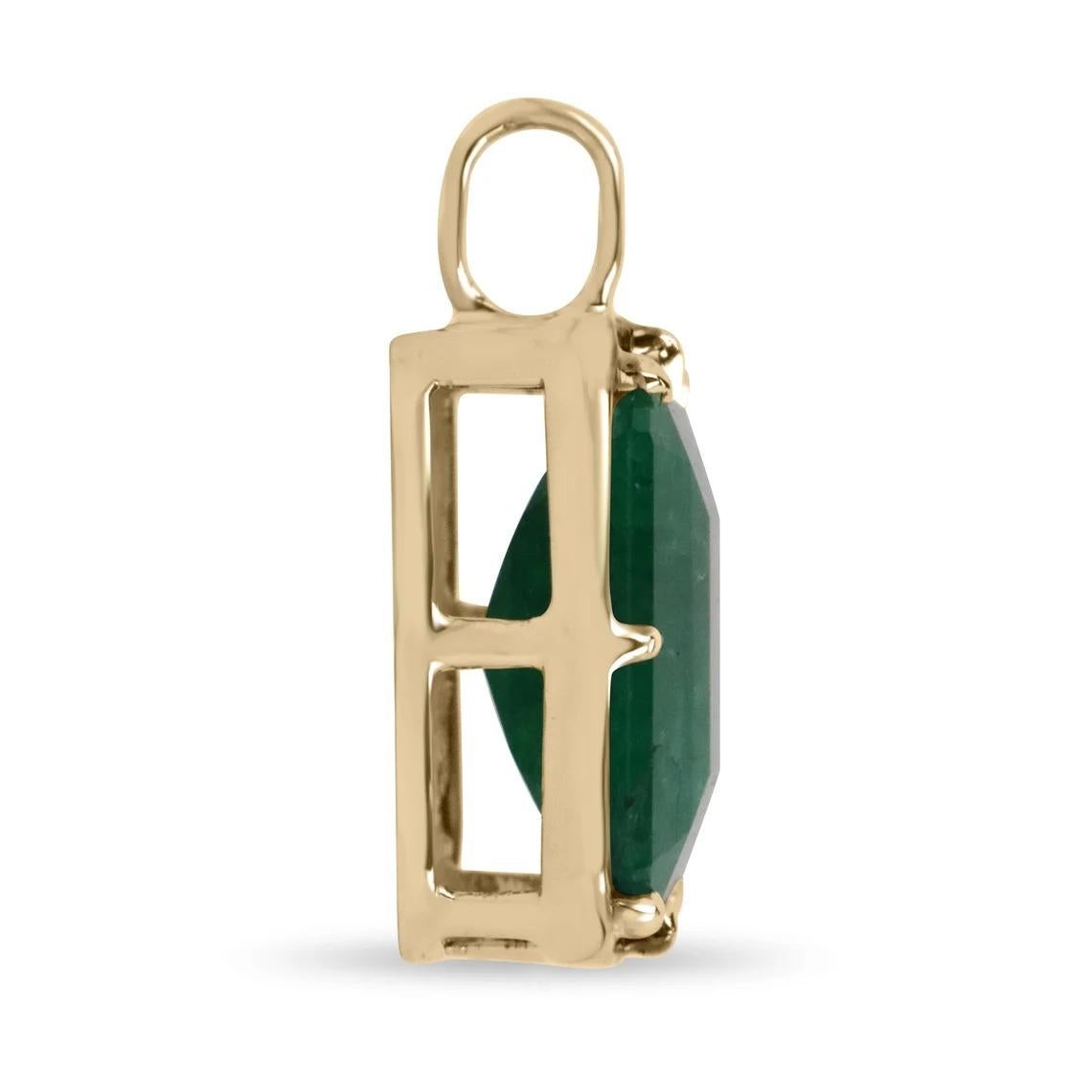 Displayed is a natural emerald Georgian-styled solitaire pendant in 14K yellow gold. This gorgeous solitaire pendant carries a full 17.50-carat Brazilian emerald in a prong setting. Black rhodium highlights the emeralds' bezel and prongs. Fully