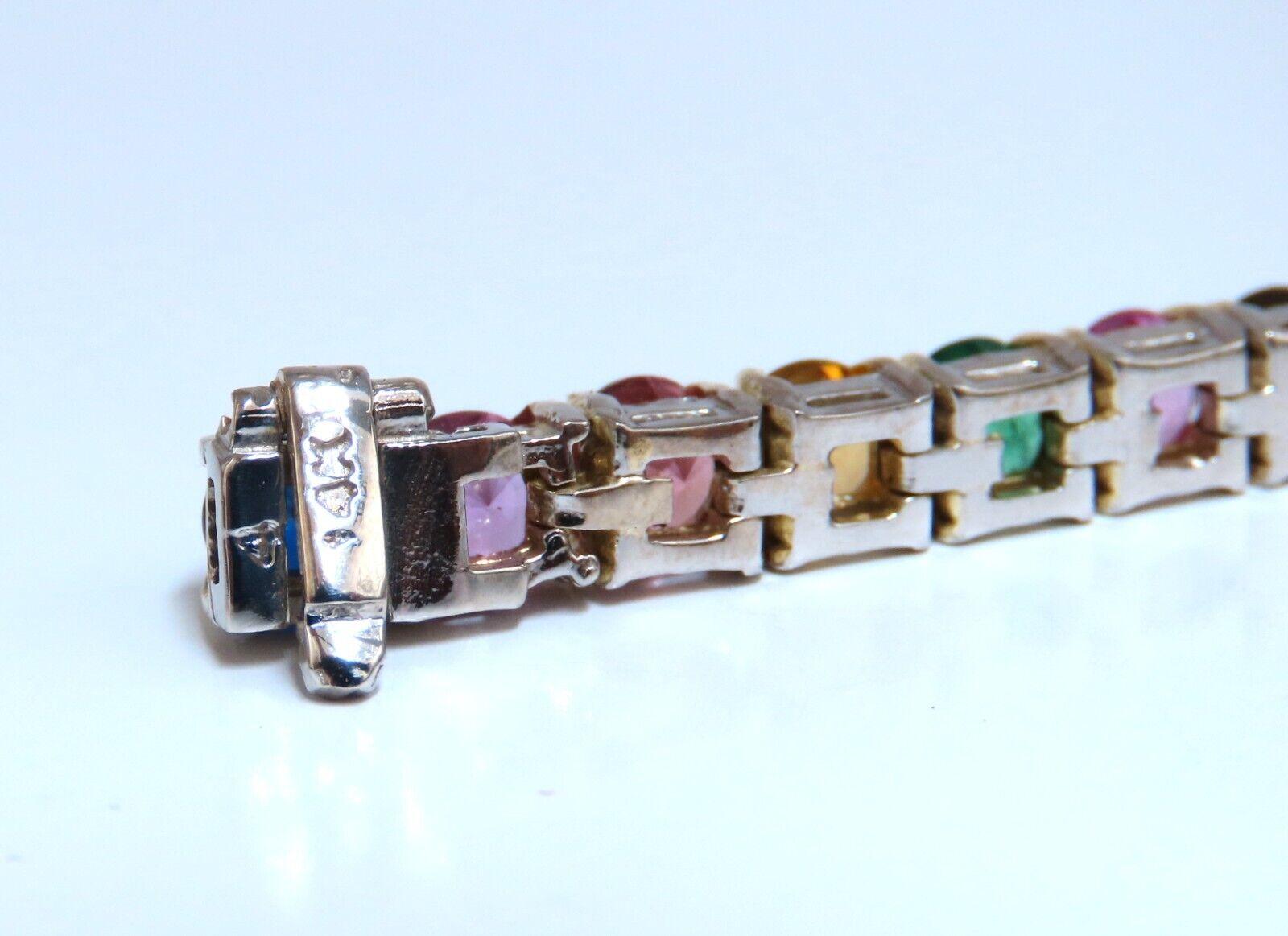 Natural Multi color Gem Line Bracelet

17.50ct Ruby, Emerald, multi-color Sapphires 

(Orange, Yellow, Blue, Pink)

Round cuts, Clean Clarity.

Secure pressure clasp and safety catch.

20.7 grams.

14kt. white gold. 

Measures 7 inches (wearable