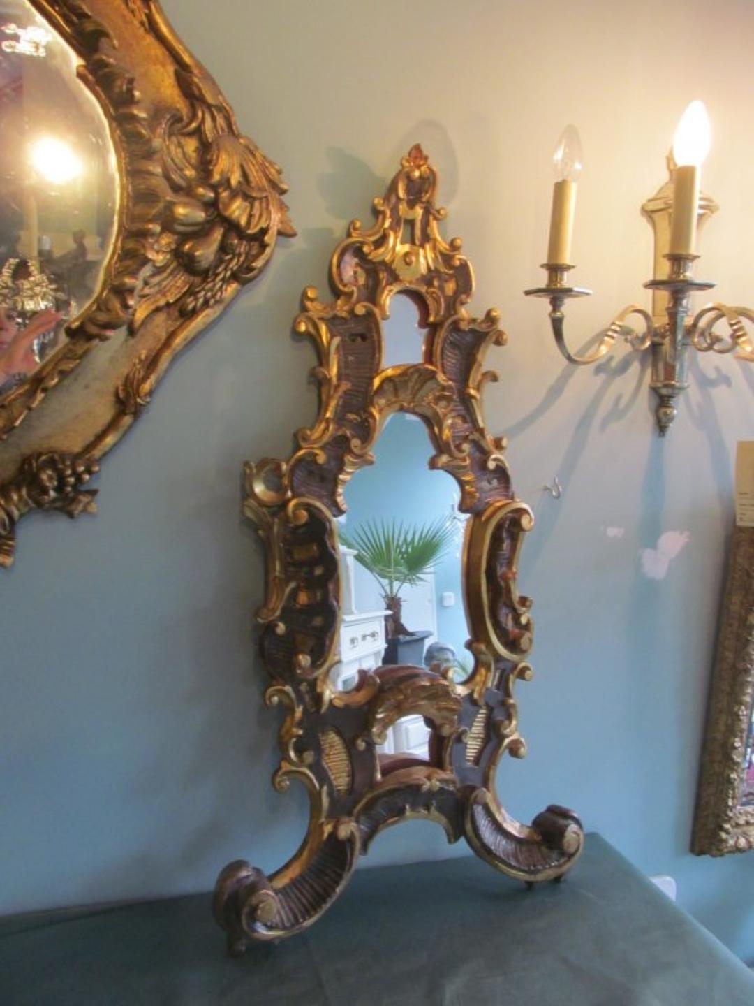 Antique Baroque table mirror from circa 1750. Made of basswood this single piece from a church in Germany convinces with its stunning carving works and the original gilding. The gilding has age related abrasions, but is in great original condition.
