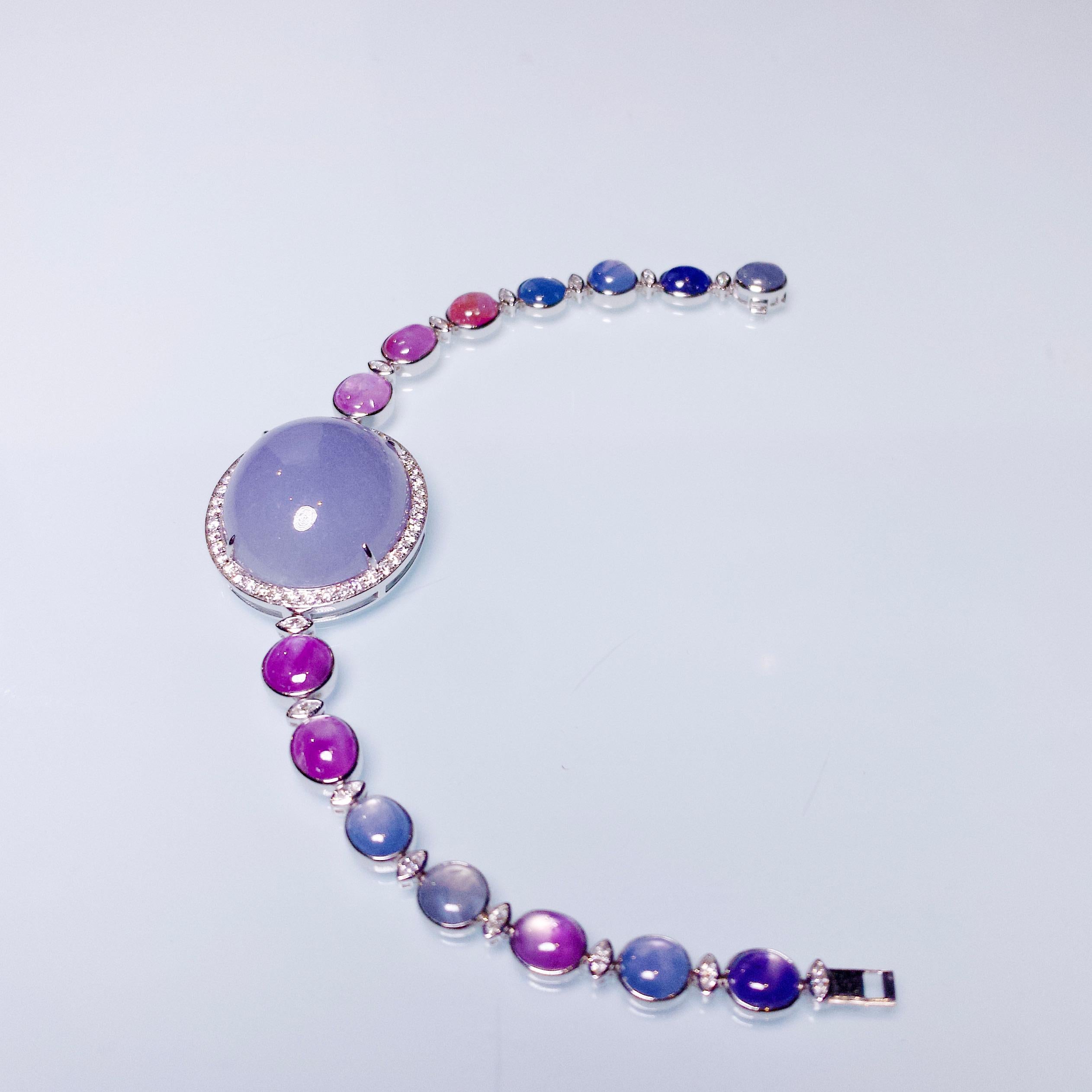 This is a watch like bracelet, with a massive Type A Lavender Jadeite Cabochon set in the middle of the bracelet. The Jadeite is then surrounded by diamond and the wrist band is made of 18K White gold with Star Sapphire and Diamonds. The star