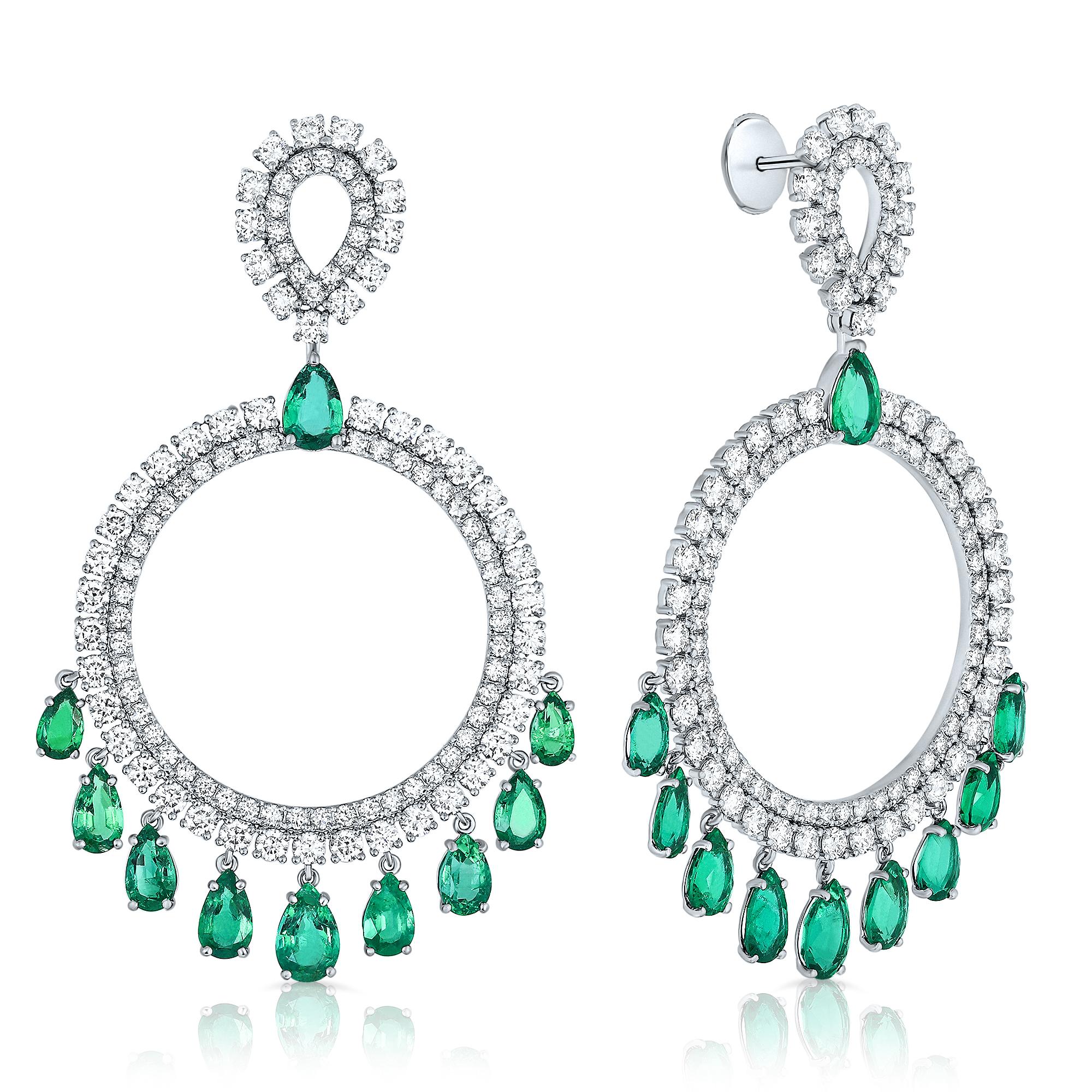 Introducing a breathtaking matched pair of 18K White Gold, Emerald, and Diamond Circular Drop Earrings. These exquisite chandelier drop earrings feature pear-shaped emerald stones totaling 9.63 carats and are accented by 216 round brilliant-cut