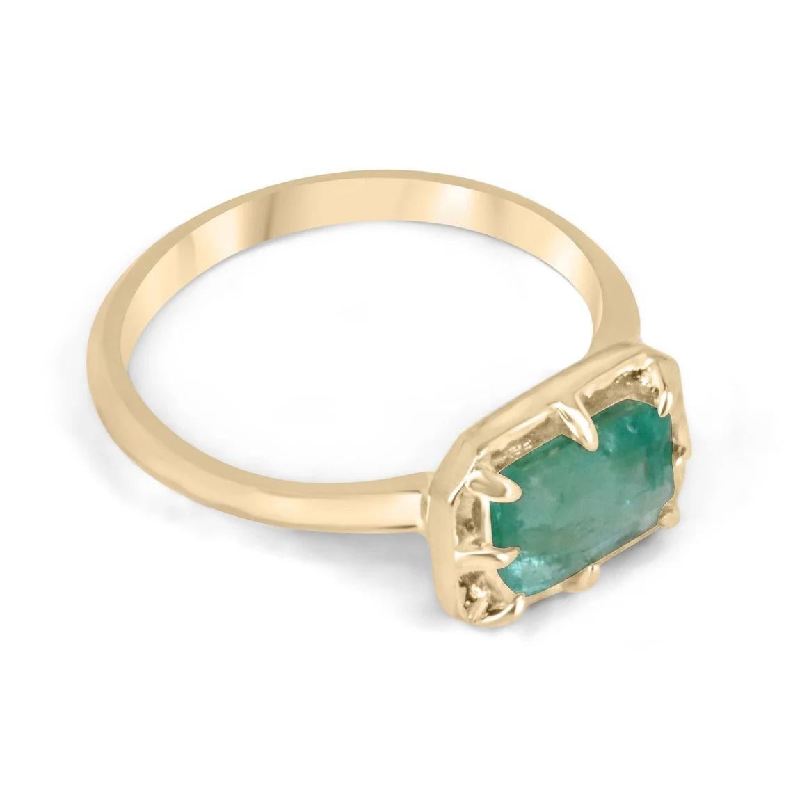 Introducing a captivating solitaire emerald ring that exudes charm and grace. This stunning piece features an approximate 1.75-carat natural emerald cut emerald, delicately set east to west in an elegant 8 prong setting. The emerald boasts a