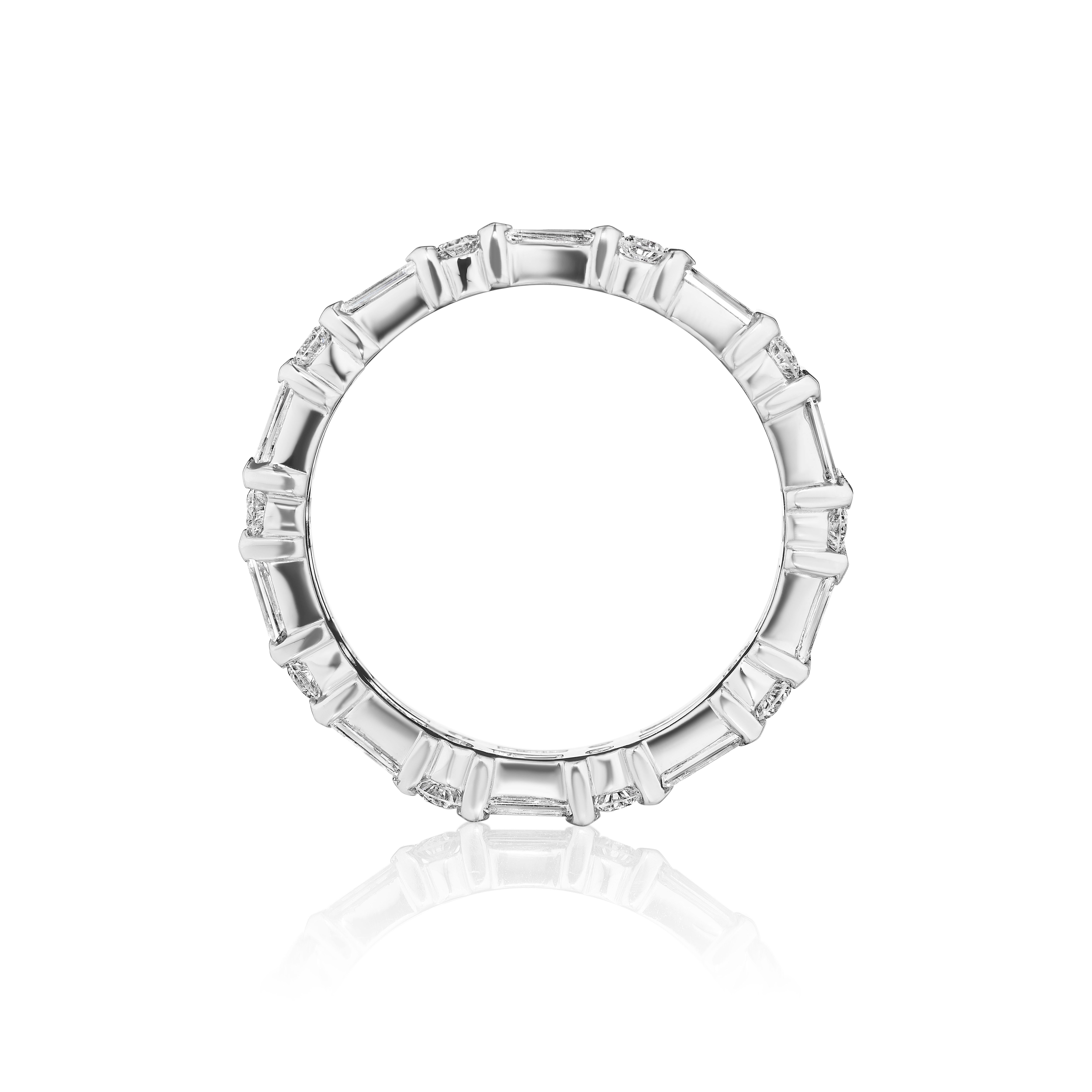 • Crafted in 18KT White Gold, this eternity band is made with 40 alternating round and baguette cut diamonds. The diamonds are secured in a bar setting and has a combining total weight of approximately 1.75 carats.
Worn beautifully on its own or
