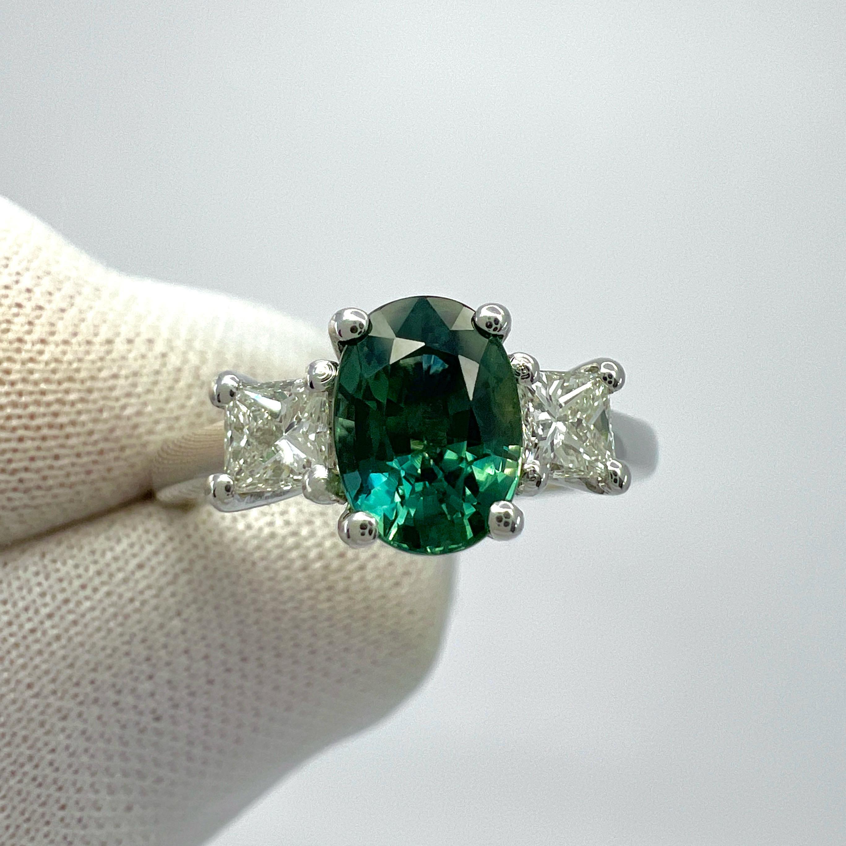 Natural Deep Green Blue Sapphire And Diamond Three Stone 18k White Gold Ring. 1.75 Total Carat.

1.39 Carat centre sapphire with a fine deep green blue colour and excellent clarity, a very clean stone, VVS. Also with an excellent oval cut showing
