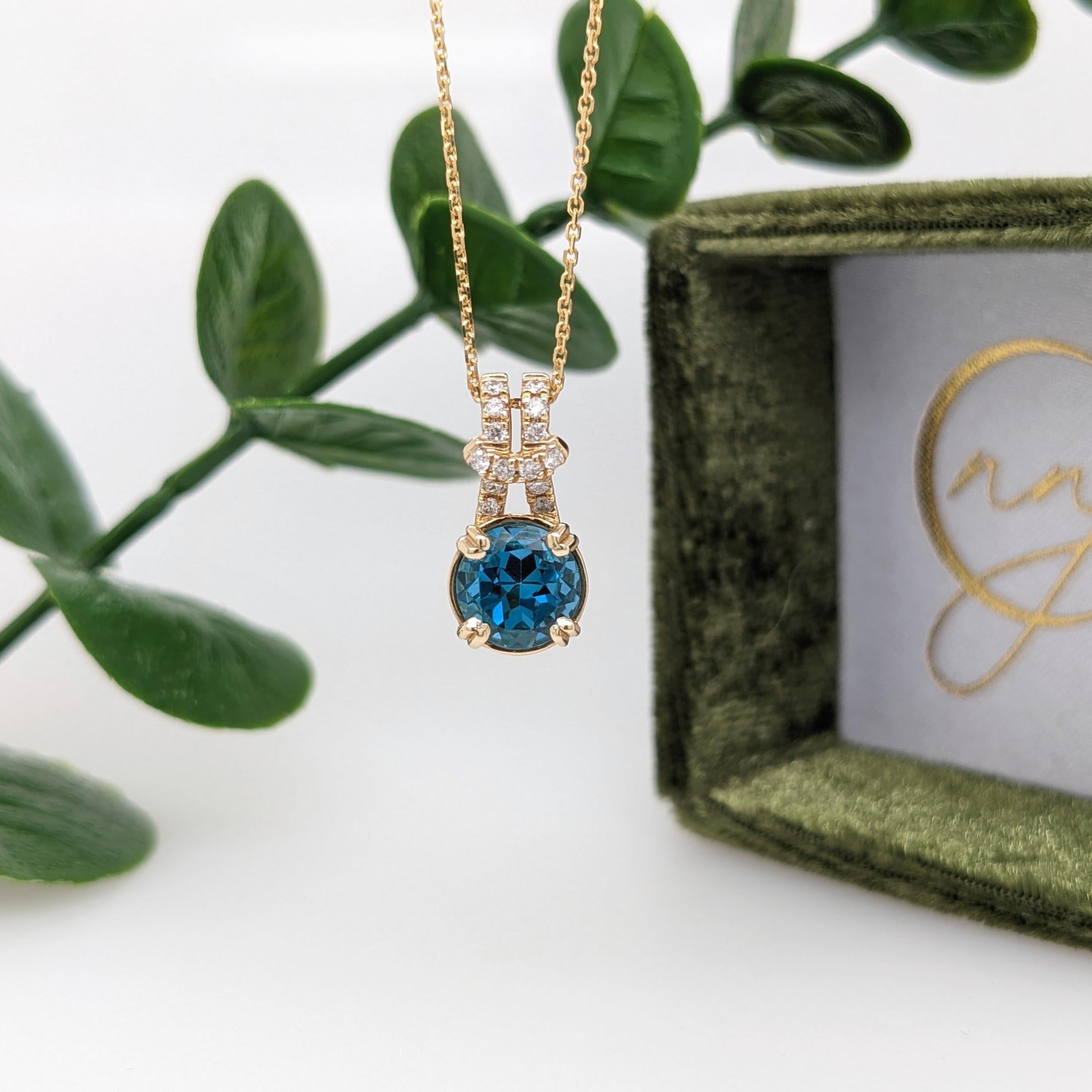 An absolutely adorable pendant featuring a beautiful blue shade of London Topaz, round cut and set in solid 14k yellow gold with all natural earth-mined diamond accents.

Perfect for gifts, anniversaries, or any special occasion!

Item Type: