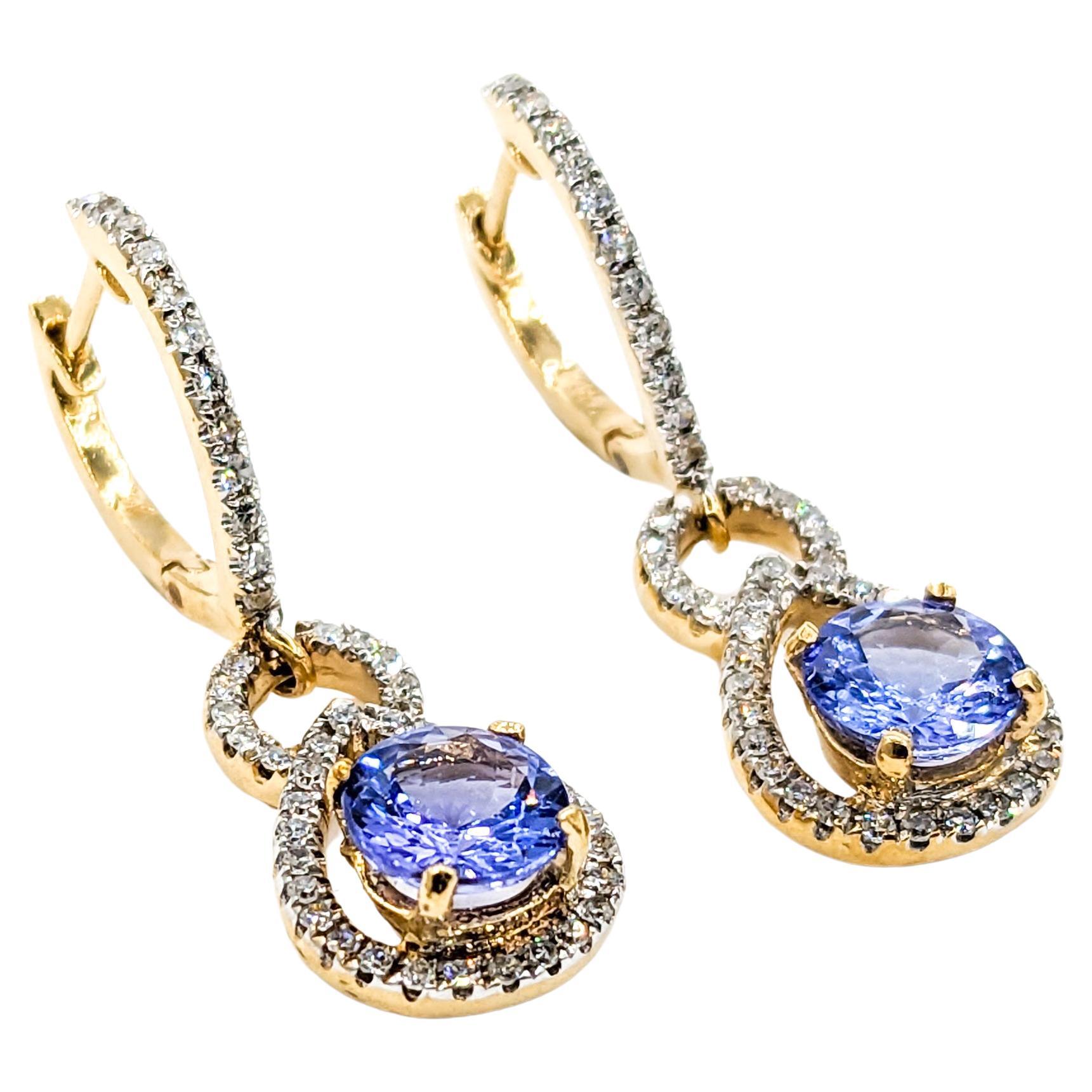 1.75ctw Tanzanite & Diamond Dangle Earrings In Yellow Gold

Introducing a stunning pair of Dangle Earrings crafted in 14kt Yellow Gold, adorned with a .50ctw of Round Diamonds. The Sparkly Diamonds exhibit I clarity and a Near Colorless white