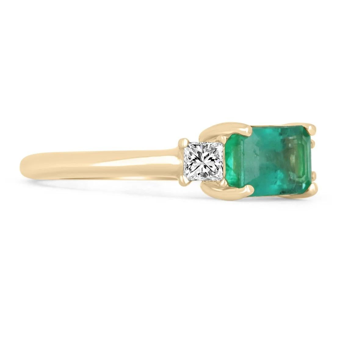 Shower her with love with this emerald and diamond three-stone ring. The center stone carries a full 1.40-carat, natural emerald originating from Zambia set east to west. The stone showcases a gorgeous green color and very good luster overall.