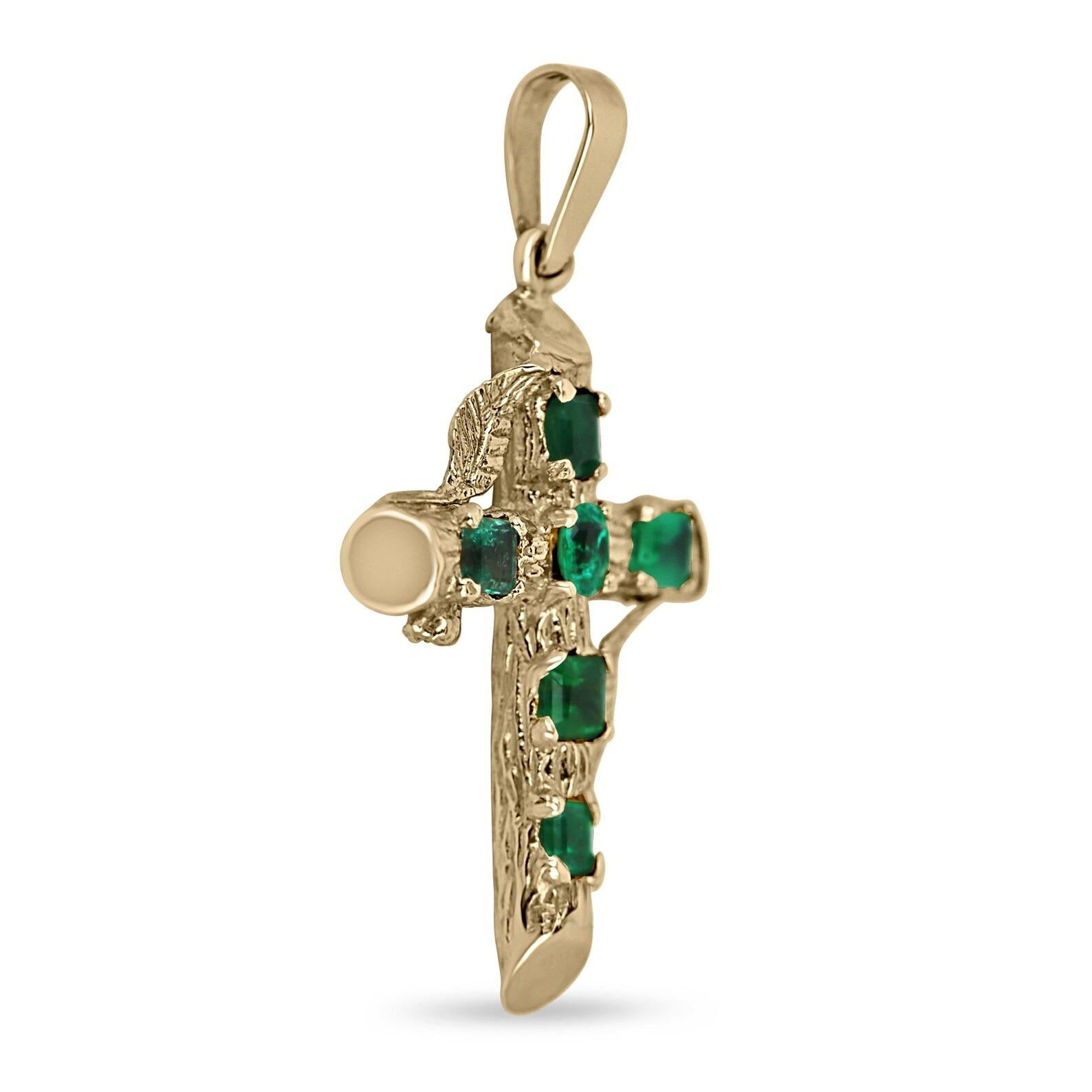 A stunning, natural deep green emerald gold cross. This remarkable piece features six, earth-mined emeralds. Gorgeous mixed shapes like emerald cut, asscher and a center set oval cut emerald. All gemstones showcase an excellent shine and vivid dark