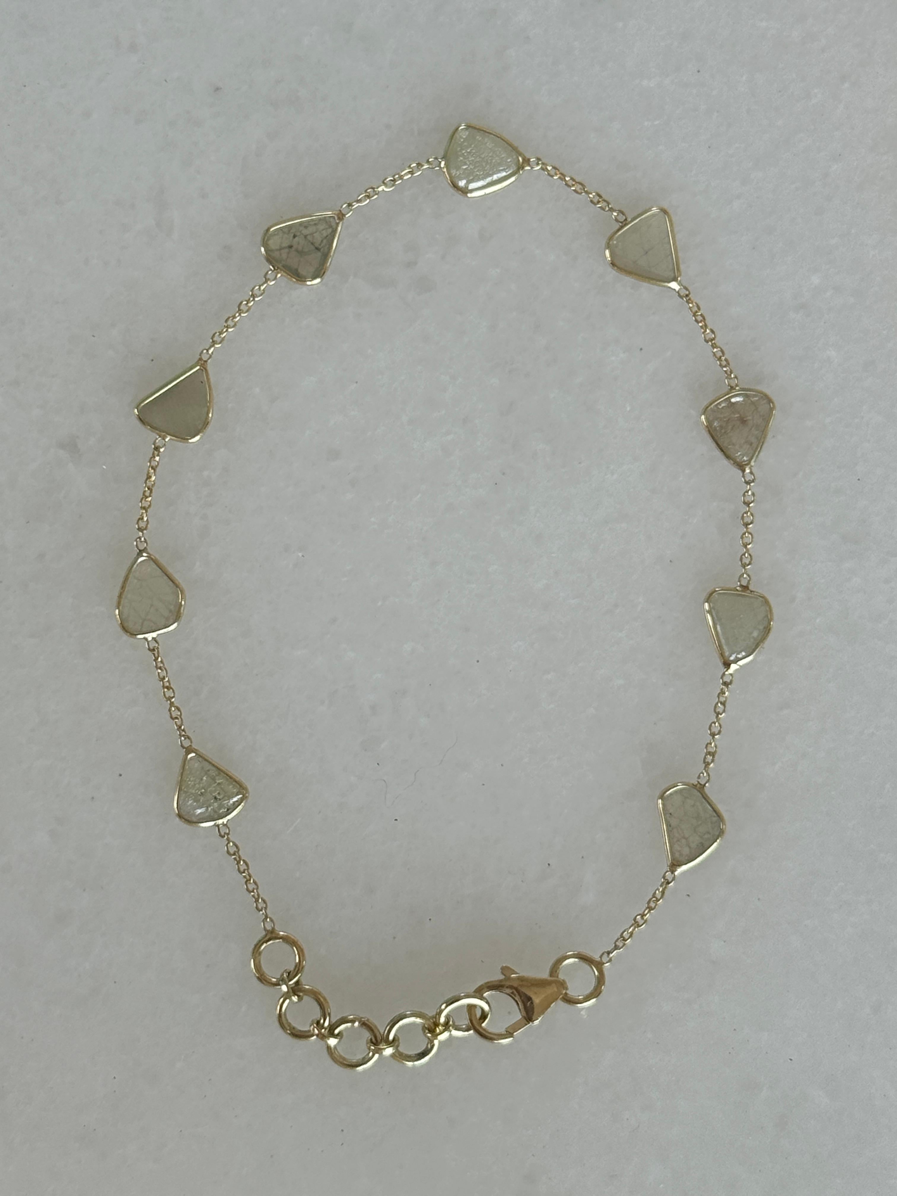 Beautiful 14K Gold bezel set diamonds slice bracelet chain. This bracelet is comprised of 9 diamond slices and measure 7 inches in length. The bracelet is adjustable to fit between 6 -7 inches with 5 gold loops that join the lobster clasp. 
When the