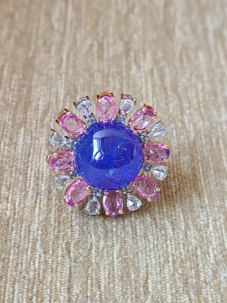 A very gorgeous and one of a kind, Tanzanite & Pink Sapphire Cocktail Ring set in 18K Gold & Diamonds. The weight of the Tanzanite is 17.60 carats. The Tanzanite is ethically sourced from Tanzanite. The weight of the Pink Sapphires is 2.80 carats.
