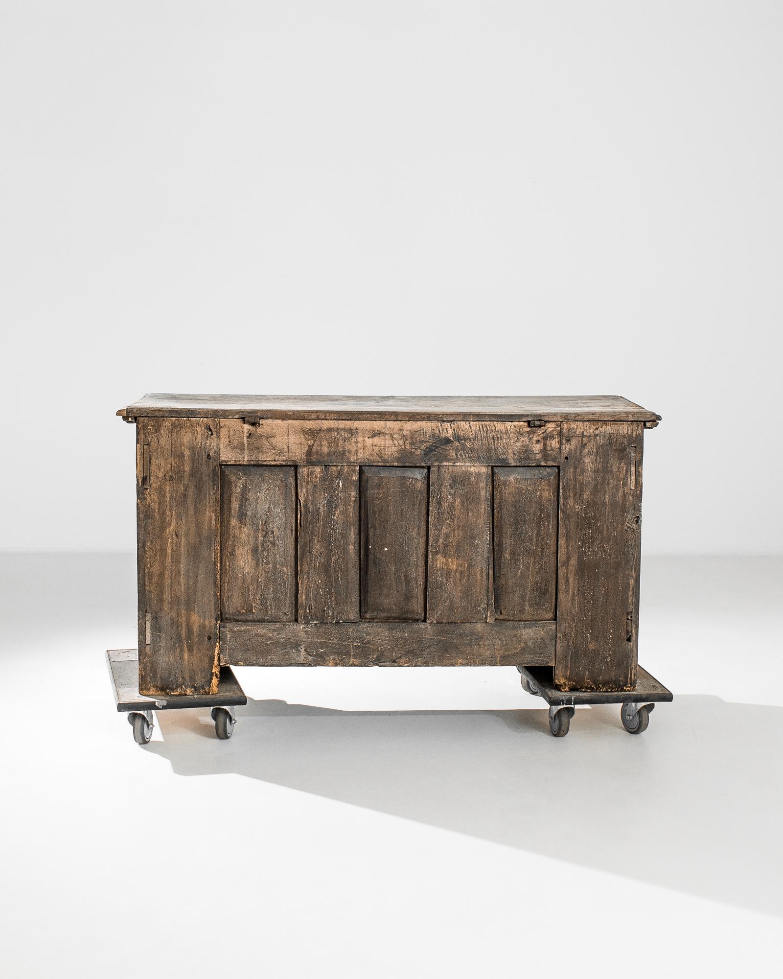 A bleached oak trunk from Germany, produced circa 1760. An antique wooden chest featuring a hinged lid with chain support and original locking iron latch and key. Decorated with geometric panels in relief at the flanks, and raised curved diamonds on