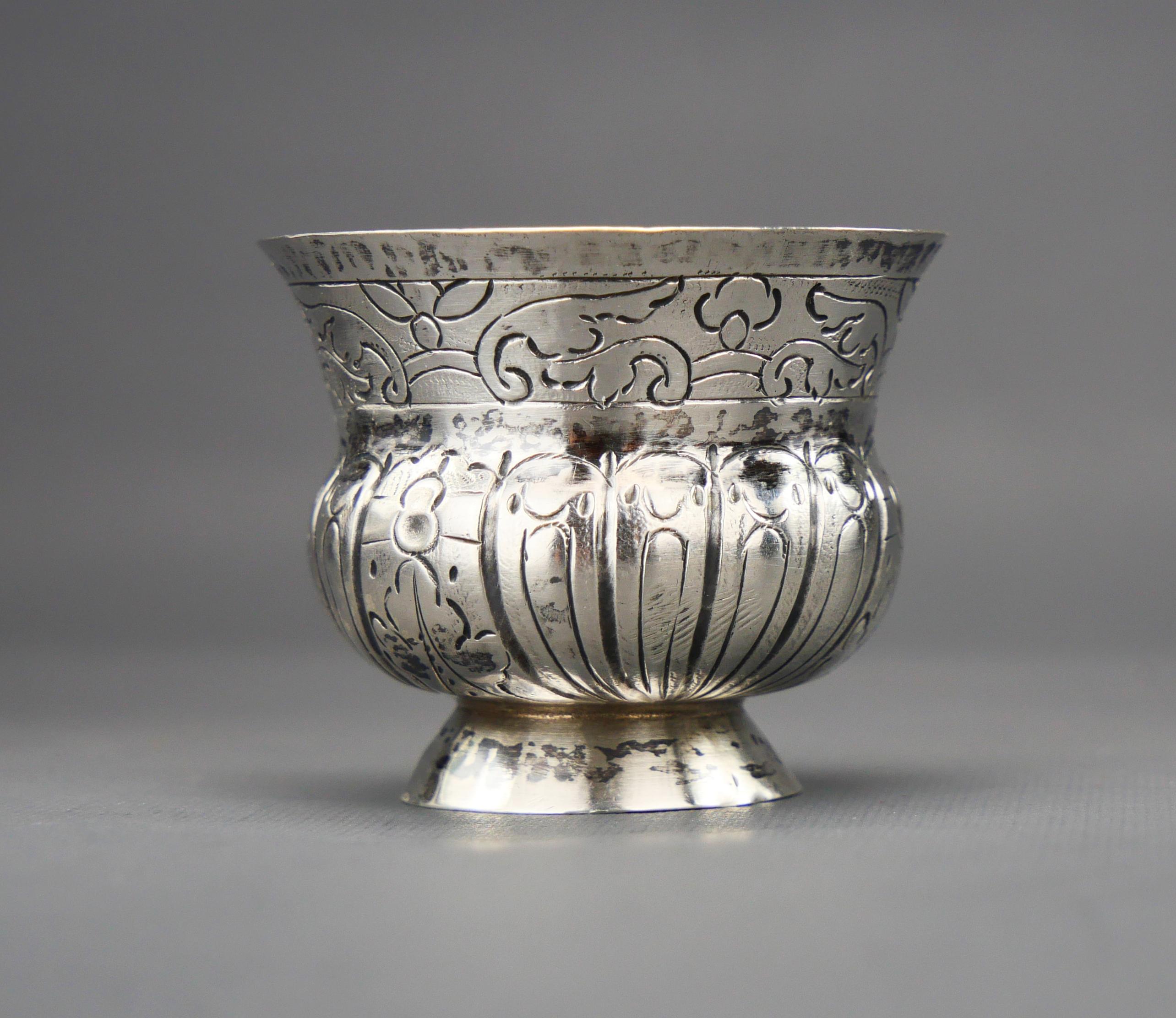 Handsome 261 -year-old Russian solid 84 Silver Vodka shot  with continuous cast or impressed / hammered floral decorations  in style very popular in Russia of that time.

Period : reign of Catherine the Great ( 1762 to 1796 ). This shot has