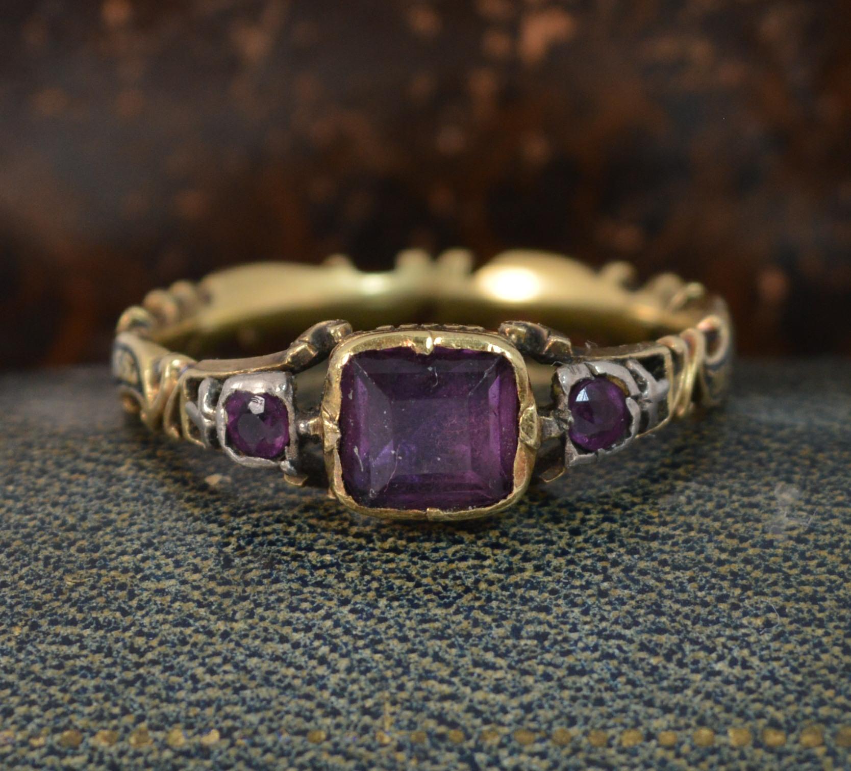 An early Georgian period mourning band or stack ring.
SIZE ; S 1/2 UK, 9 US
Set with three foiled back amethysts to front and amazing reverse to the cluster head.

Wave shape band throughout with black enamelling. Enamel to read ' Henry Drake, ?? 10