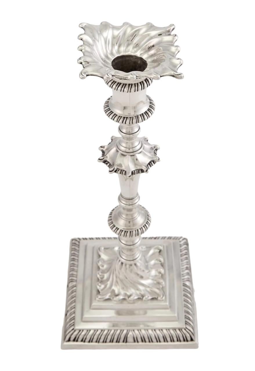 Presenting a distinguished set of four George III sterling silver candlesticks, skillfully crafted in 1764 by the esteemed silversmith Ebenezer Coker. Each candlestick stands as a testament to the elegance and artistry of the Georgian era.

These