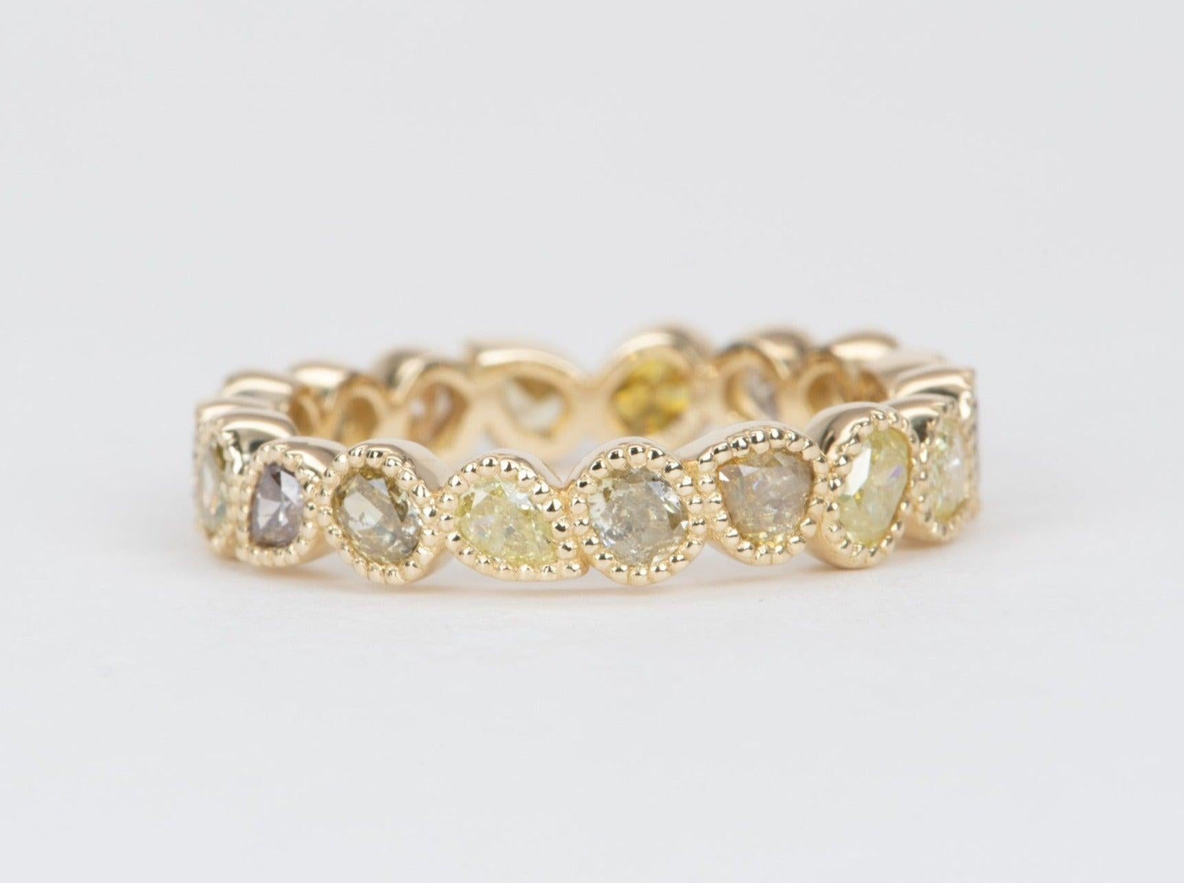 ♥ A one-of-a-kind band set with a full row of natural fancy color diamonds
♥ The beautiful mixed-shape diamonds alternate in directions, forming a tight yet interesting design all around the ring. No two diamonds are the same! You see different