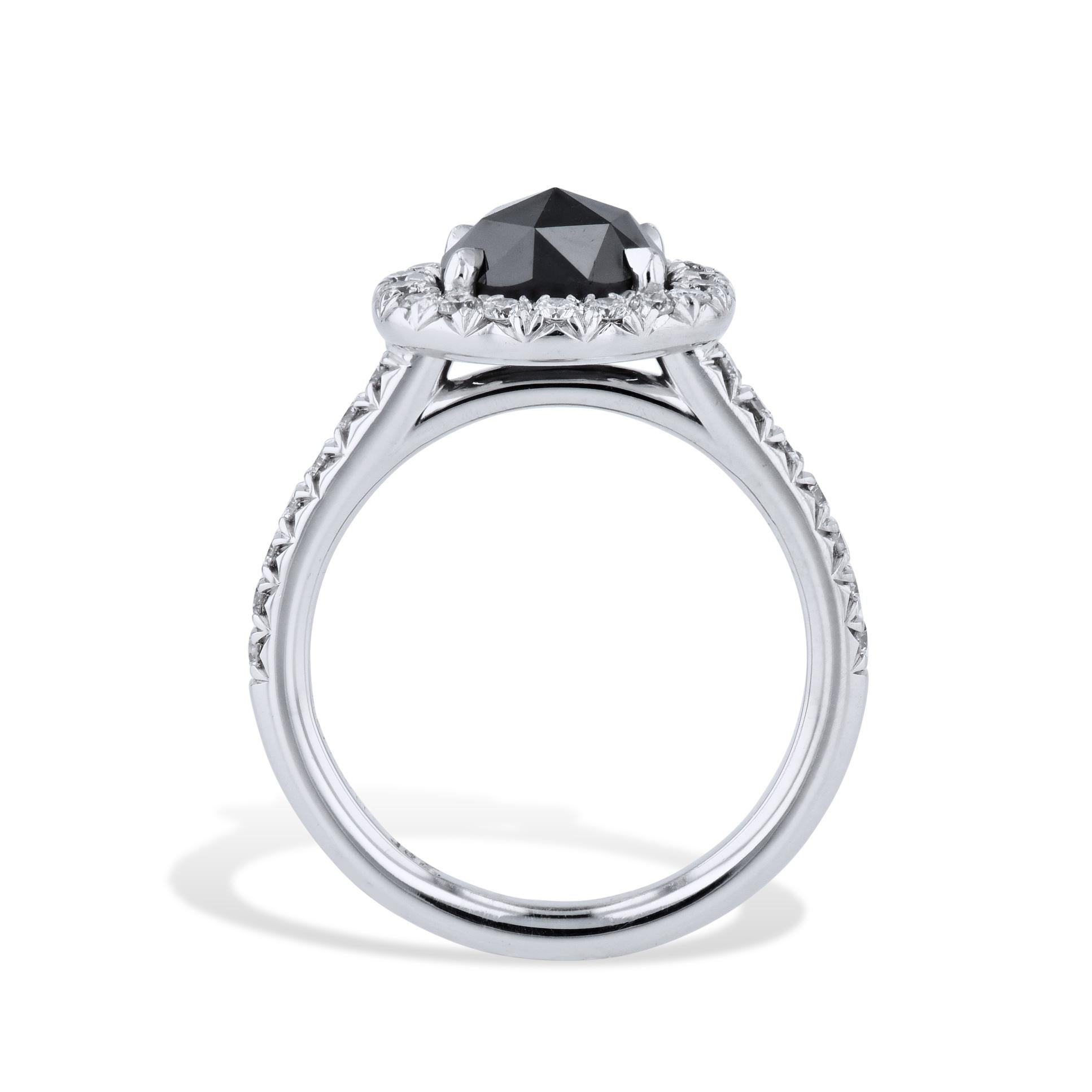This stunning black diamond ring is hand crafted with 18kt white gold. Further embellished with diamond pave around the black diamond and down the shank, it is sure to captivate from every angle. An exquisite handmade piece from the HH