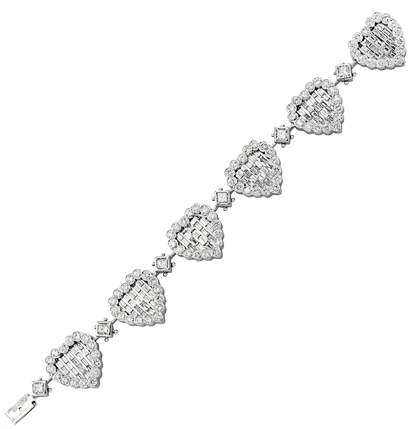 Feel the love with this enchanting heart diamond bracelet crafted in 18 karat white gold, featuring 96 round brilliant cut diamonds weighing approximately 11.5 carats total, F-G color, VS clarity, 20 baguette cut diamonds weighing approximately 3.00