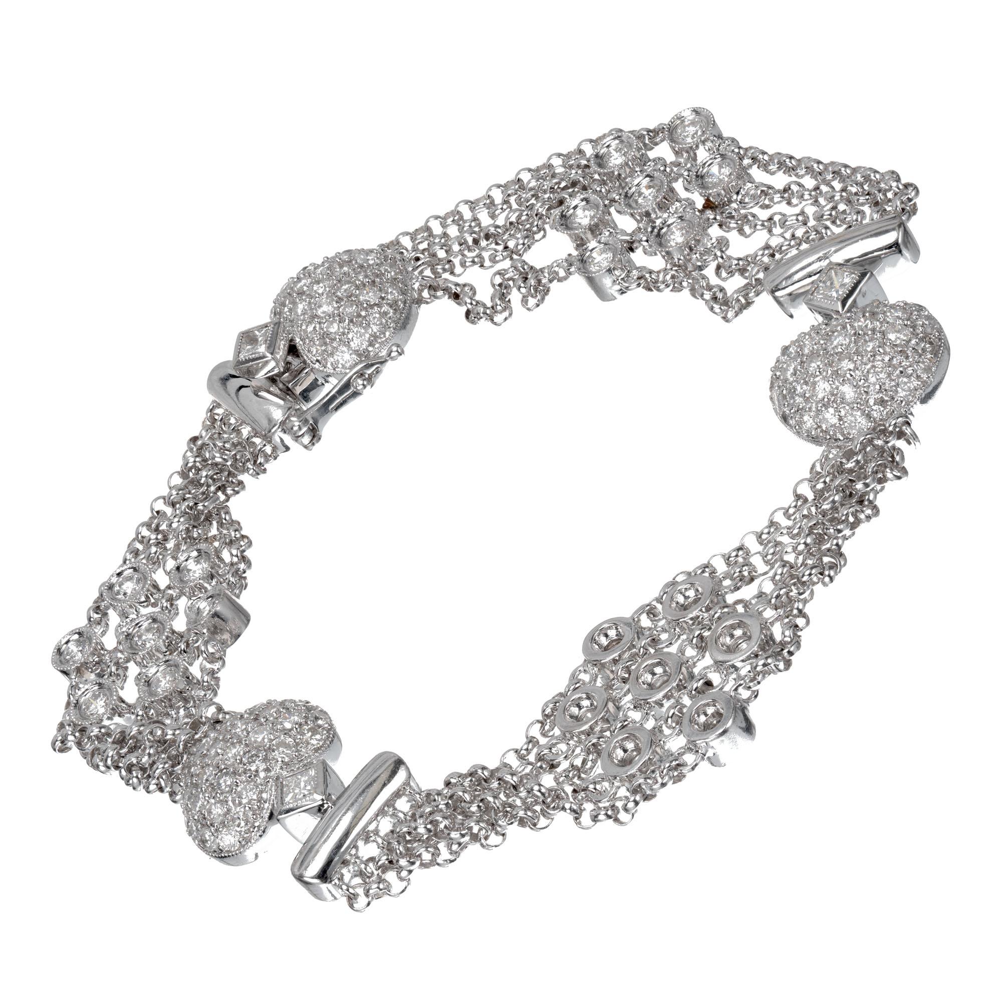 Five row multi-strand 18k white gold diamond link bracelet with heart shaped diamond spacers. Hidden built in catch. 

21 round brilliant cut diamonds G-H SI, approx.  .63cts
99 round brilliant cut diamonds H-I SI-I, approx. .99cts
3 princess cut