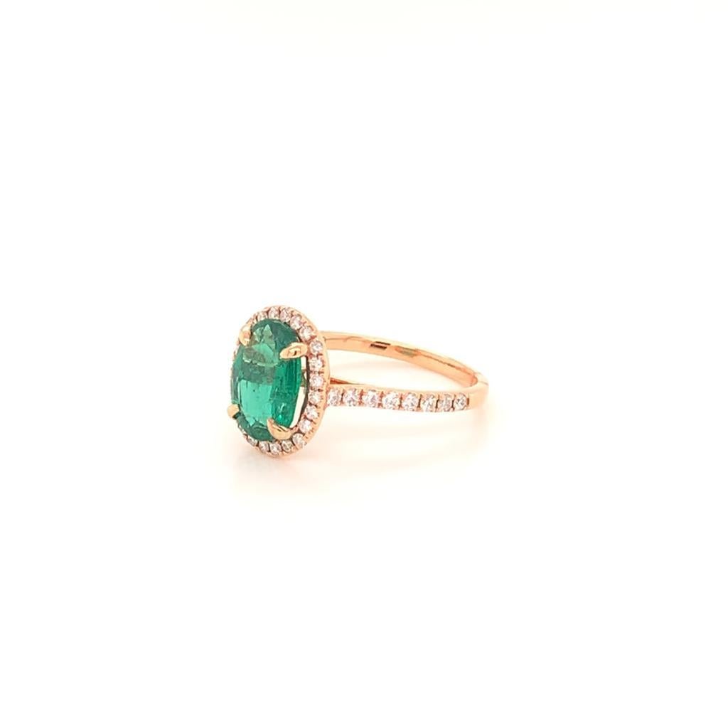 This extraordinarily beautiful ring is made of a stunning Oval cut Emerald weighing approximately 1.77 Carats surrounded by glimmering Round Brilliant Diamonds in a halo setting that also extends its 18K Rose Gold band. The pure perfection of the