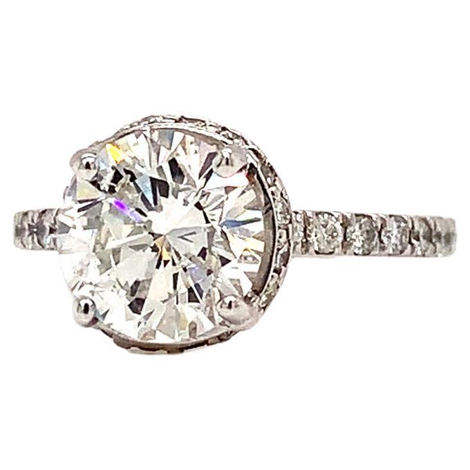 A stunning, fine and impressive contemporary 1.77 carat Center diamond halo ring This stunning, fine Round cut diamond ring with halo has been crafted in 18k white gold. The pierced decorated mount displays a feature 1.77Ct Round cut Center diamond.