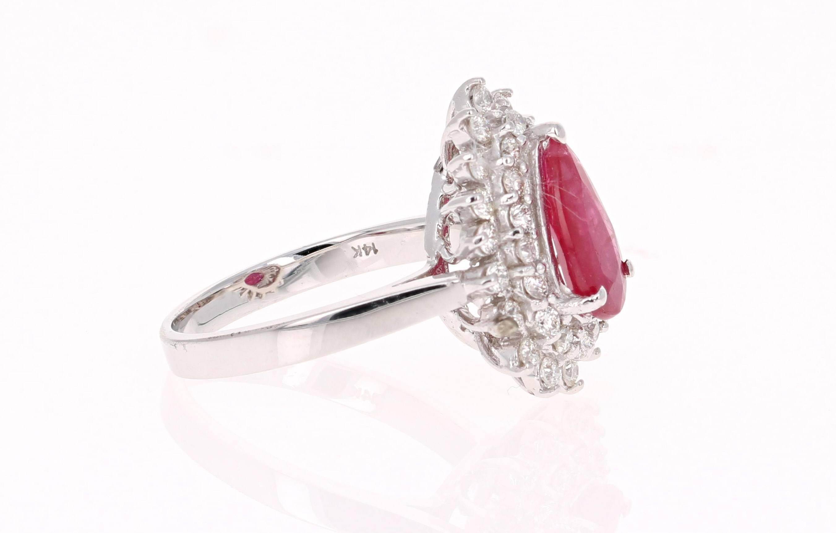 This ring is truly a beauty! 
There is a Pear Cut Ruby set in the center of the ring that weighs 1.36 carats.  There are also 34 Round Cut Diamonds that weigh 0.41 carats (Clarity: VS2, Color: H).  The total carat weight of the ring is 1.77 carats. 