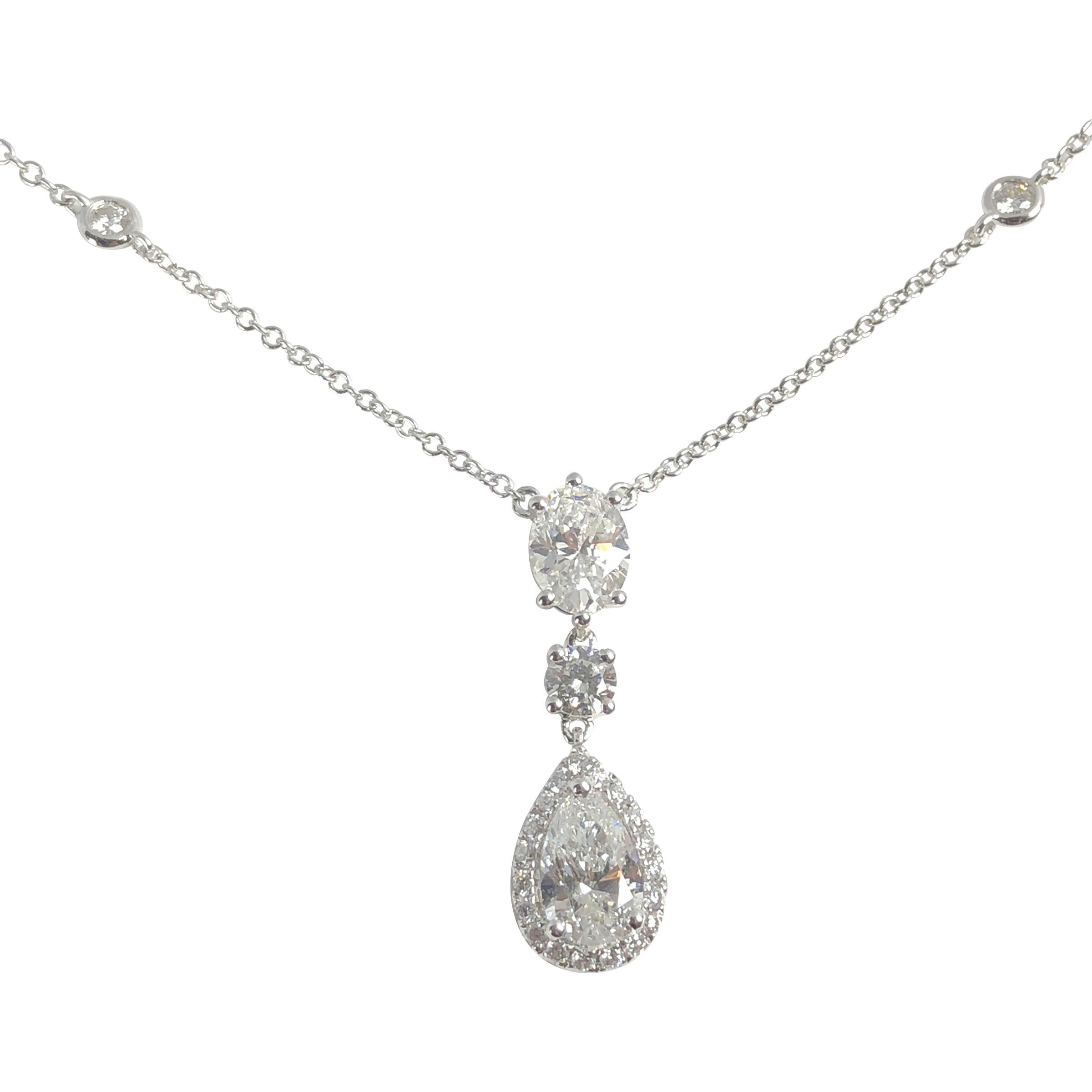 This pendant features a stunning three-tier design, showcasing a meticulously selected combination of diamond shapes. An Oval cut, a Round diamond, and a Pear Shape diamond are expertly arranged, creating a harmonious blend of shapes that draw the