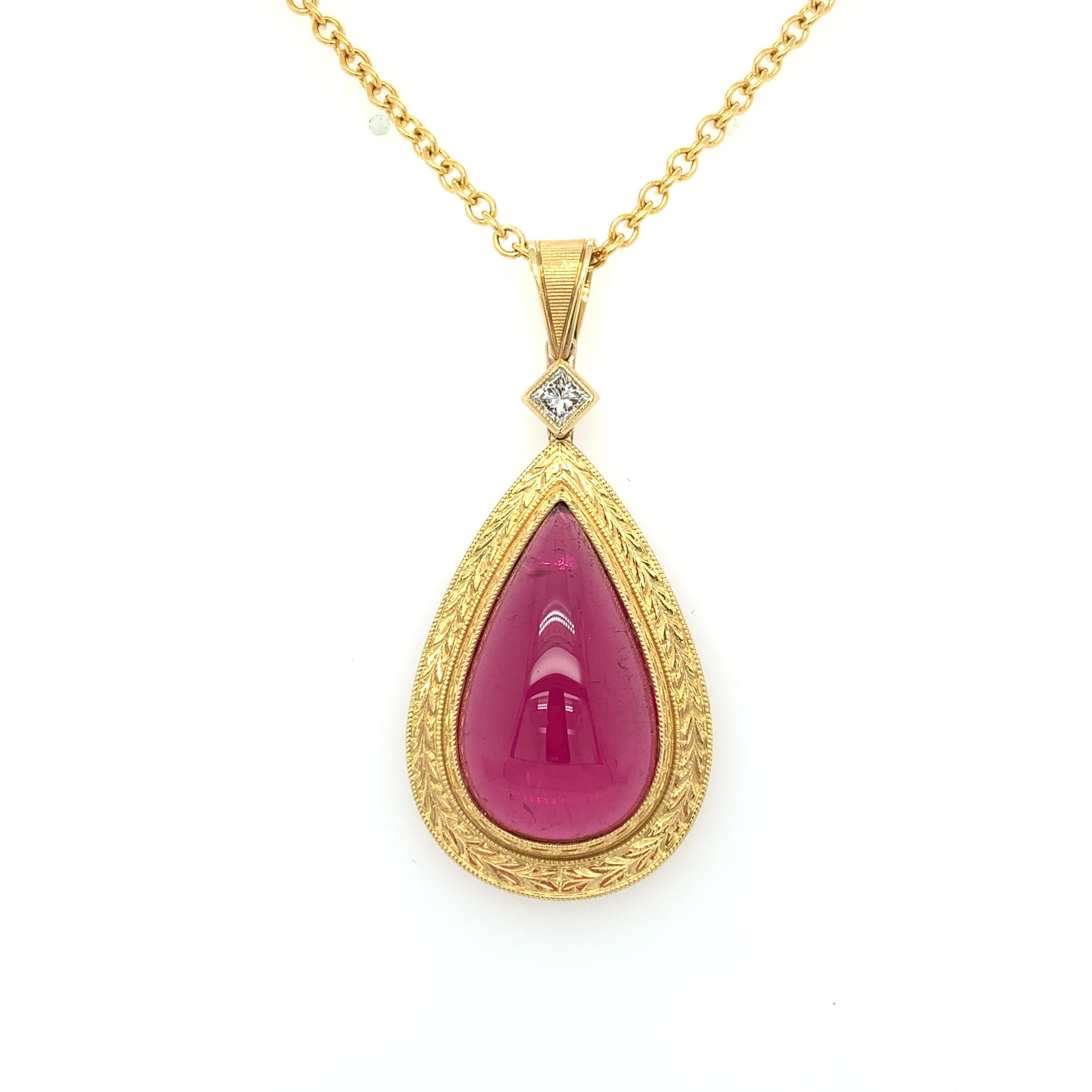 This fuchsia-red tourmaline pendant features a large, 17.75 carat gem-quality pear-shaped rubellite cabochon and is the definition of a statement piece! It is beautifully set in a hand-engraved yellow gold bezel, suspended from a sparkling princess