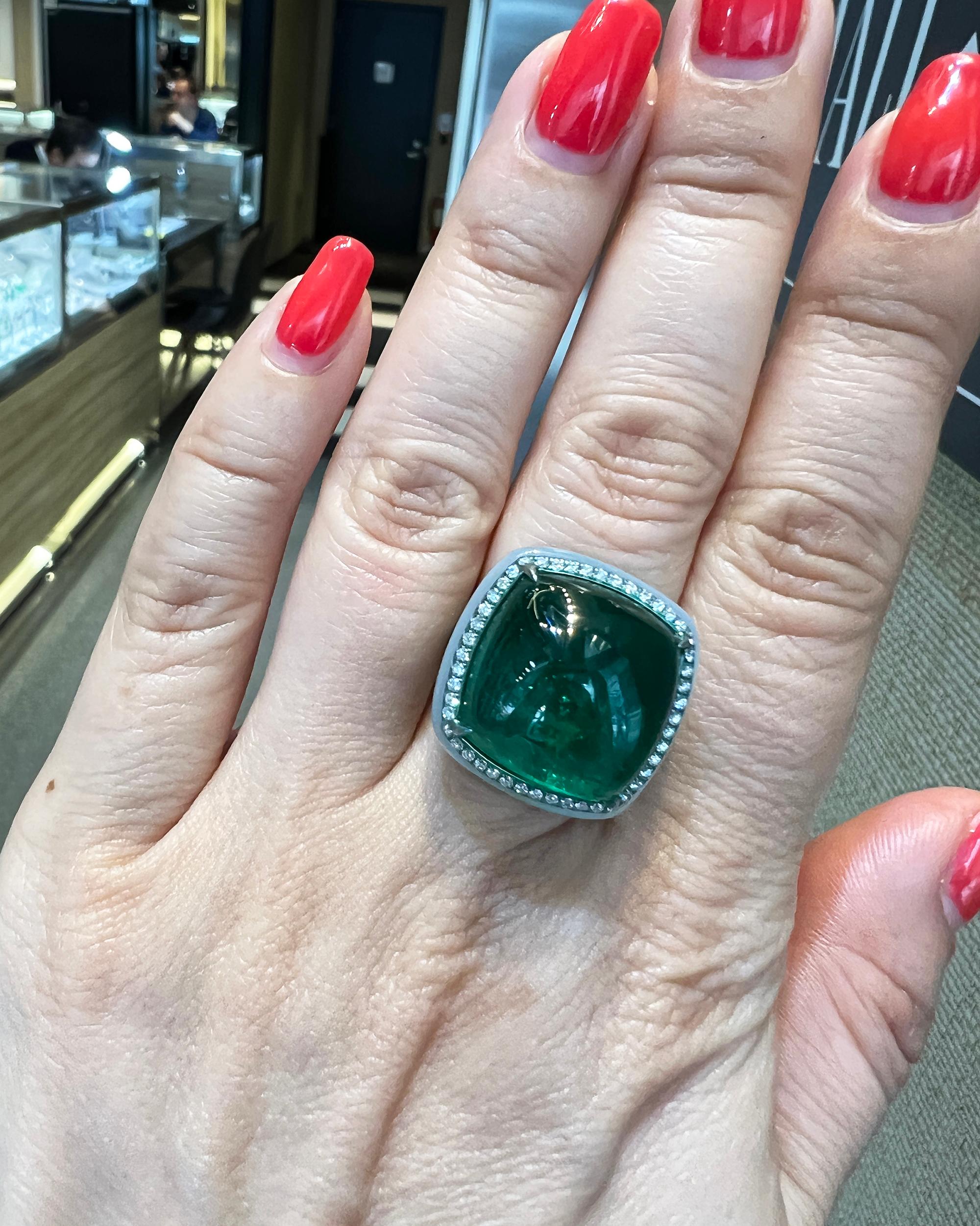 A stunning cocktail ring embellished with a cabochon emerald, opal and diamonds and set in a titanium mounting.
The ring is featuring:
17.76 carat center cabochon emerald, certified by GRS stating that it's of Colombian origin with moderate clarity