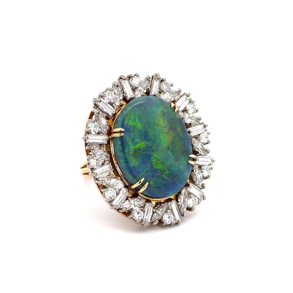 Simply Beautiful! Black Opal and Diamond Solitaire Platinum Statement Vintage Cocktail Ring. Centering a securely nestled Hand set 17.77 Carat Black Opal. Surrounded by Baguette, Marquis and Round Brilliant Cut Diamonds, weighing approx. 5.41tcw.