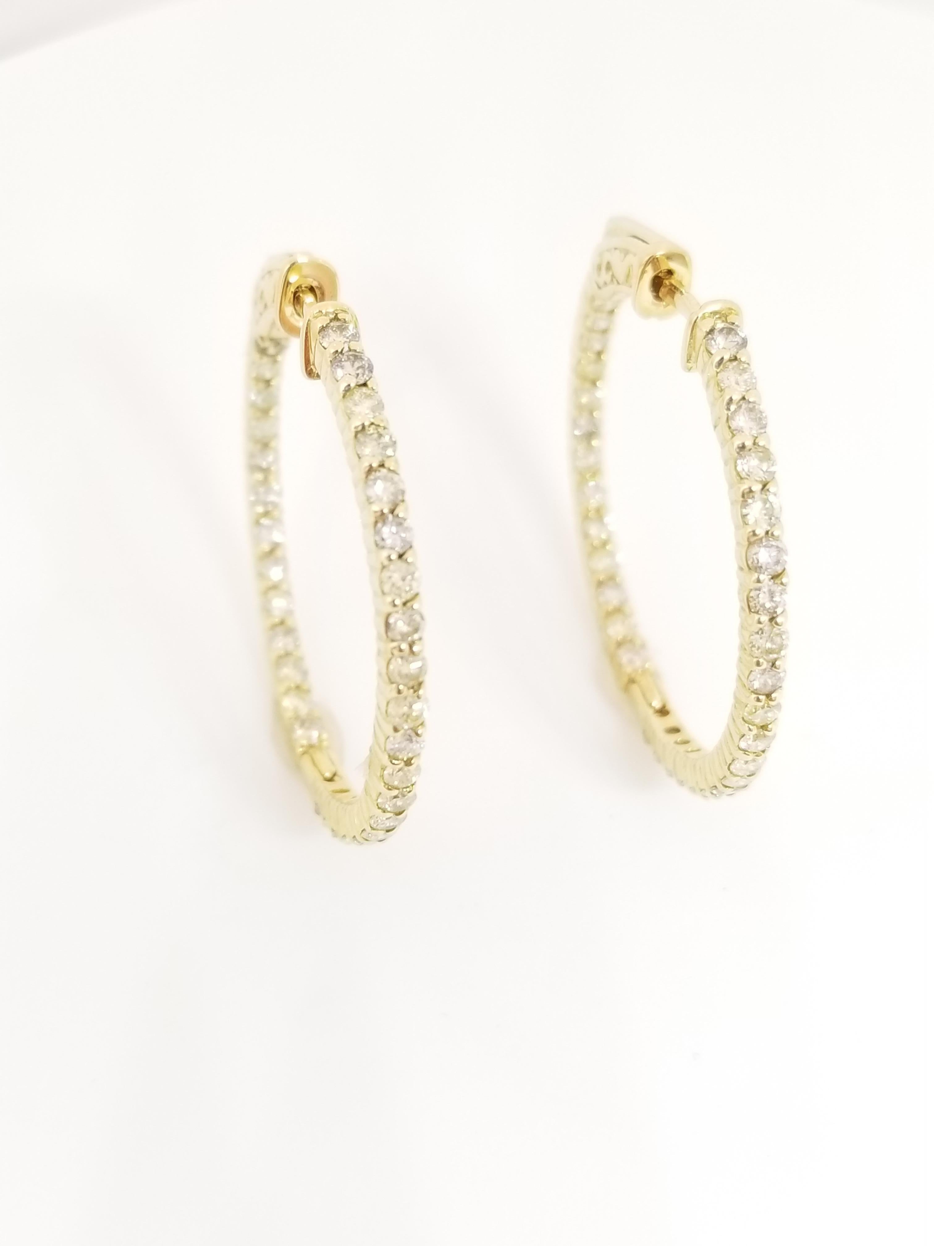 Beautiful pair of diamond inside out hoop earrings in 14k yellow gold. Secures with snap closure for wear. Elegance for every moment.

Average Color I, Clarity SI, 
Measures 1.25 inch in diameter. 