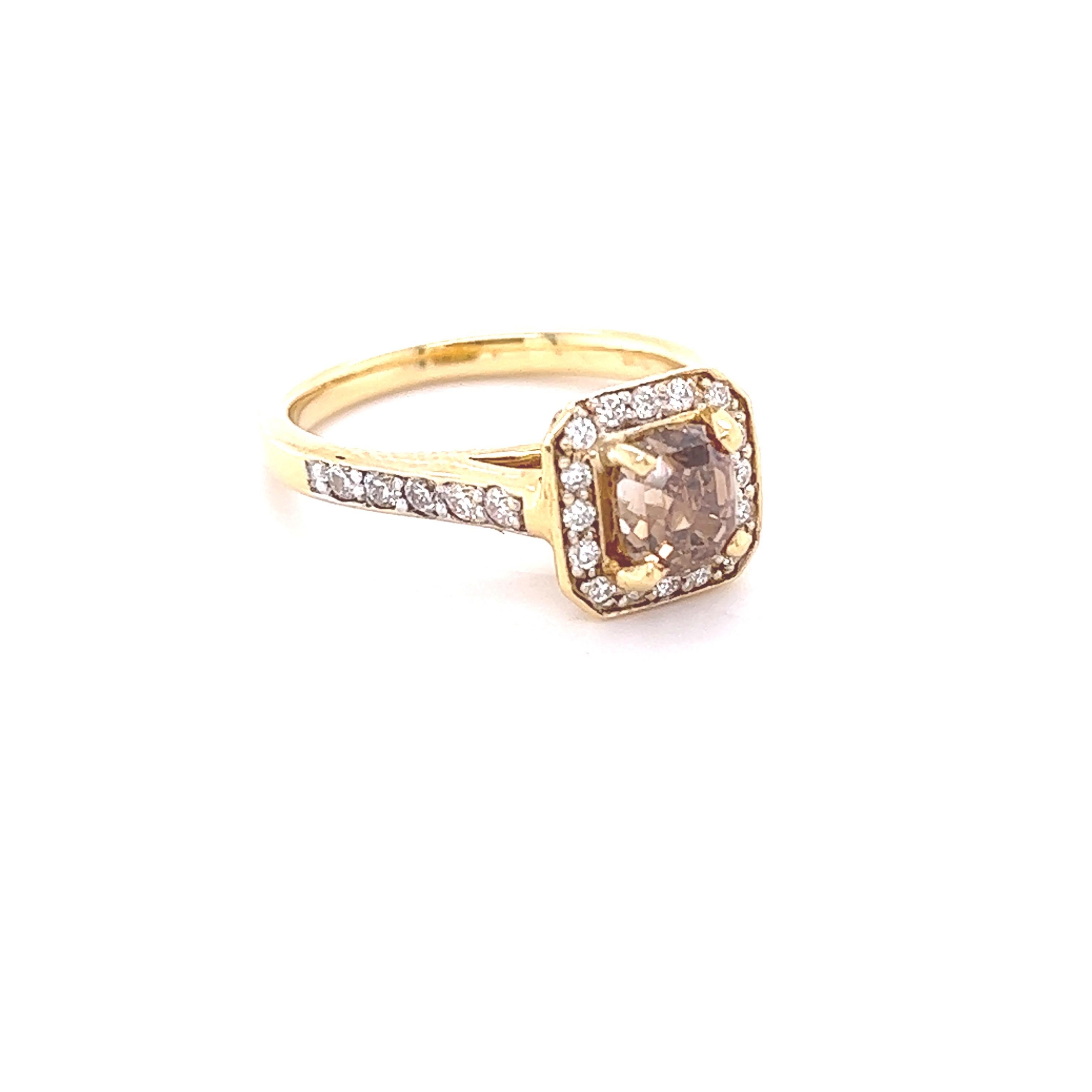 Dieser Ring hat einen natürlichen champagnerbraunen Diamanten im Kissenschliff mit einem Gewicht von 1,33 Karat, der von 32 weißen Diamanten im Rundschliff mit einem Gewicht von 0,45 Karat umgeben ist. Klarheit: VS, Farbe: H
Der zentrale